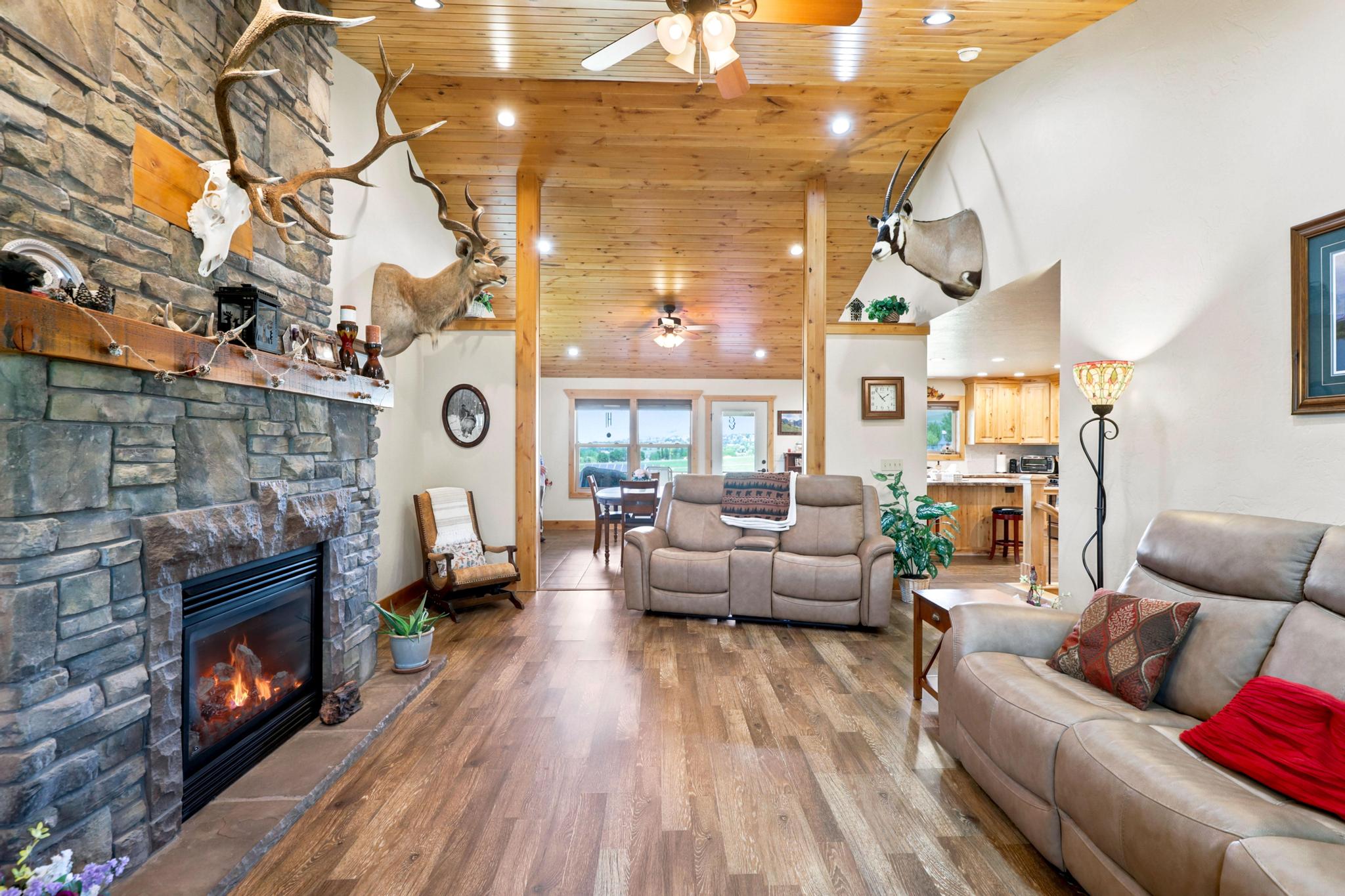 Vaulted wood-paneled ceiling with recessed lighting and ceiling fans