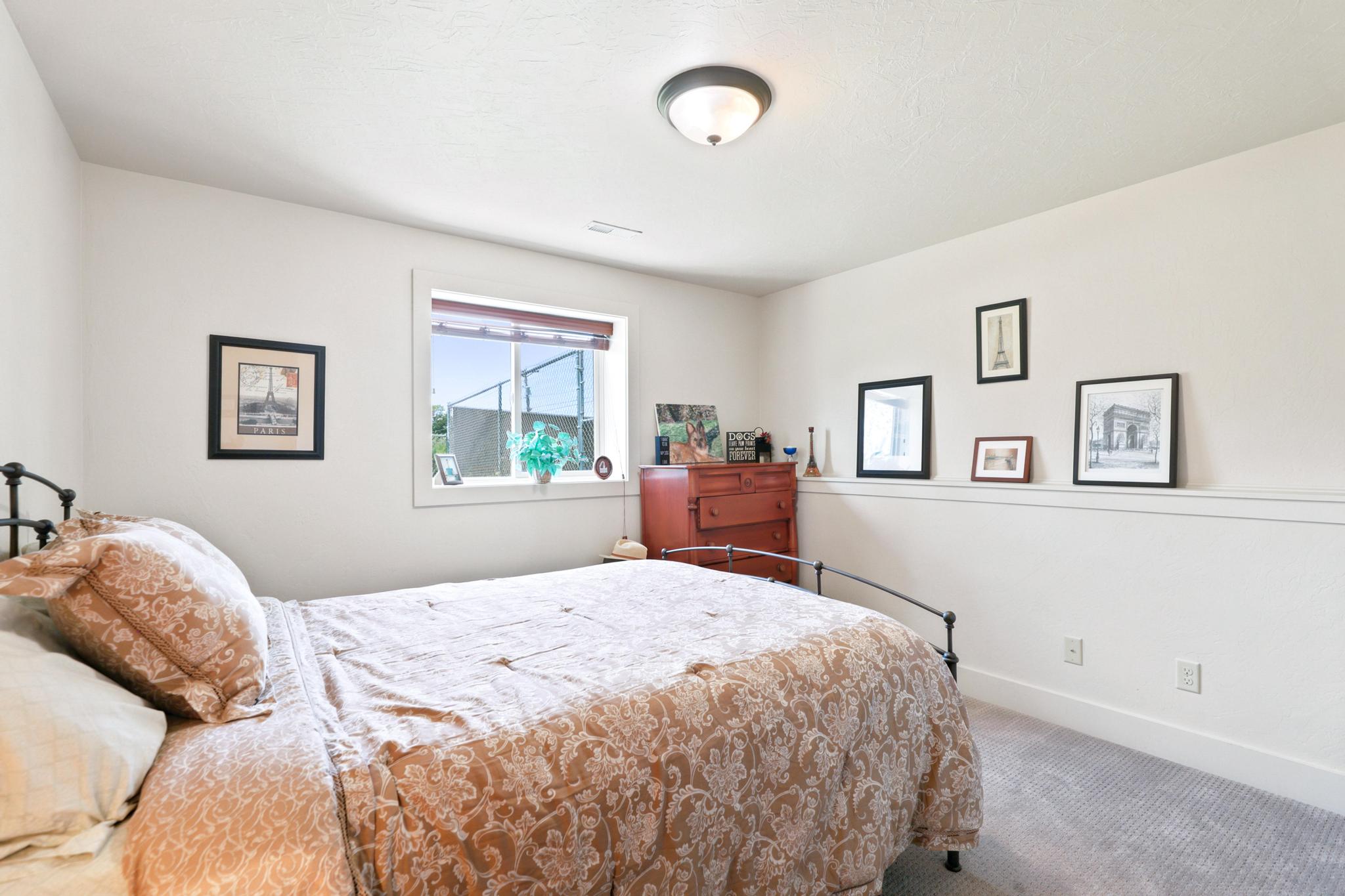 Room with light-toned walls and grey patterned carpeting