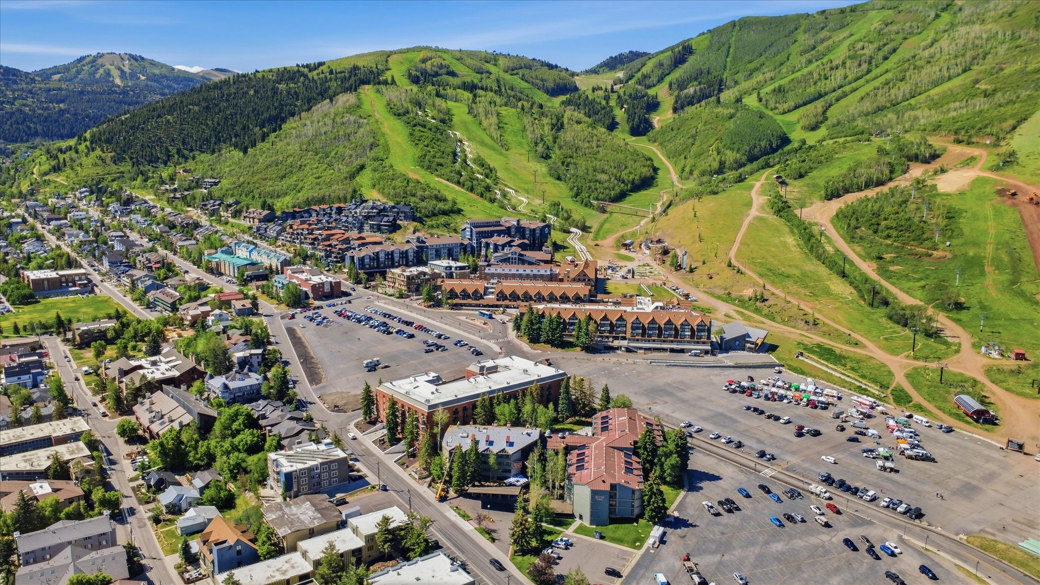 Expansive aerial perspective showcasing a mountainous terrain with verdant slopes