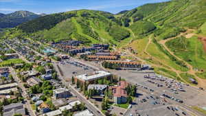 Expansive aerial perspective showcasing a mountainous terrain with verdant slopes