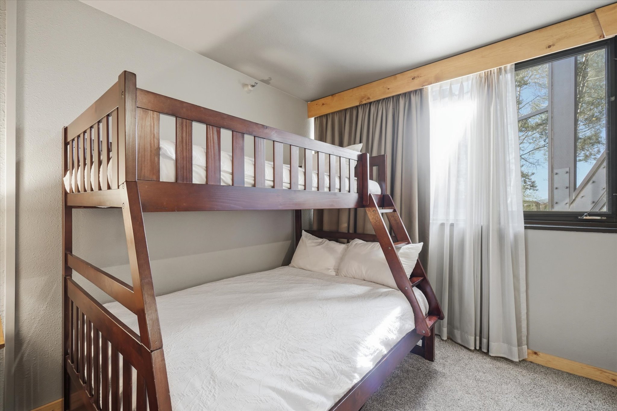 Solid wood bunk beds feature a built-in ladder