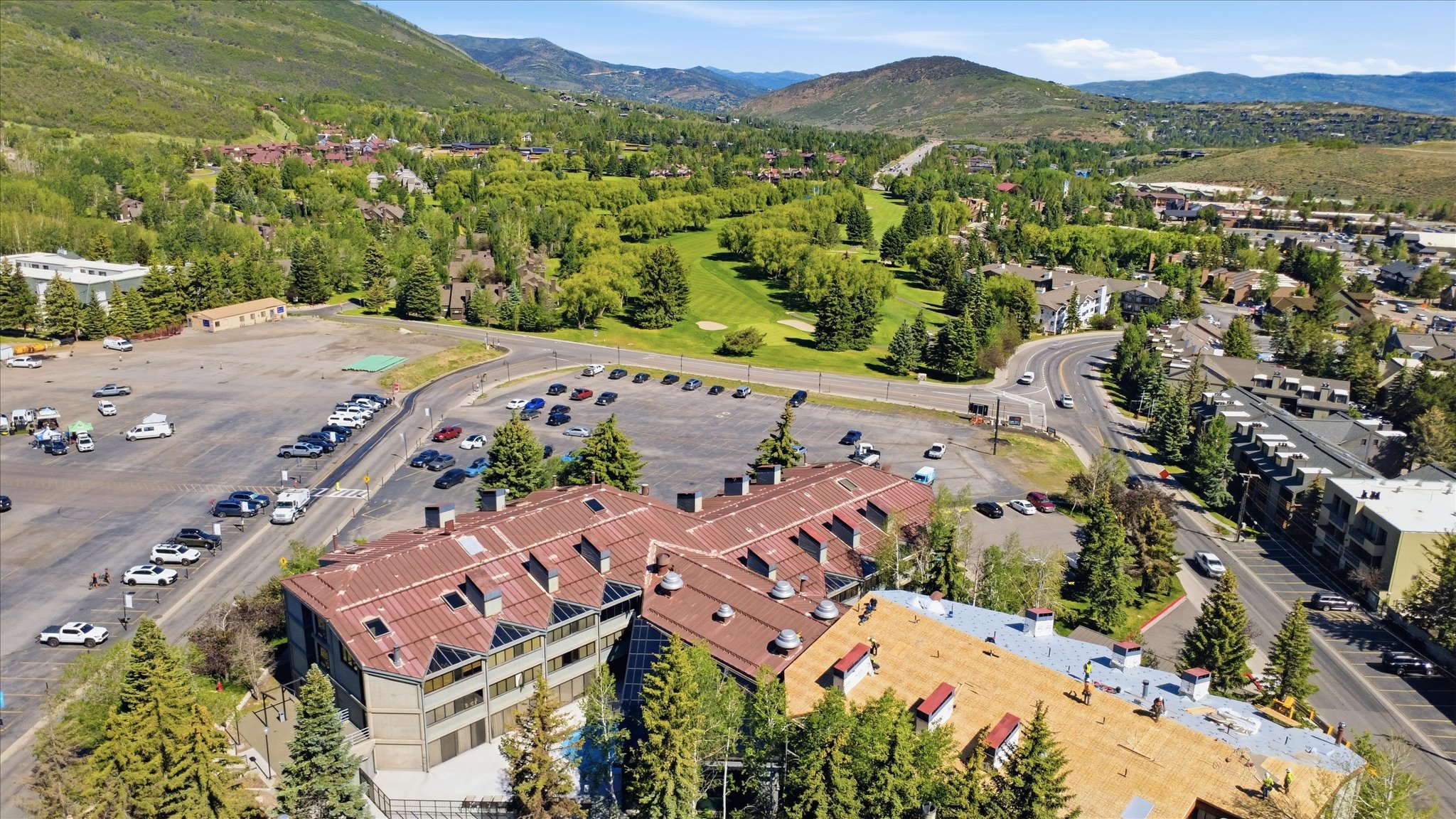 Aerial perspective showcasing a multi-story building with a brown metal roof and exterior facades