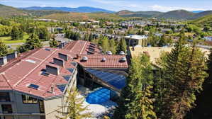 Architectural complex featuring a multi-level roofline, solar panel installation, and a prominent skylight structure