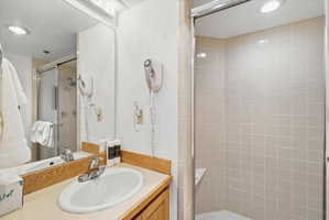 Bathroom featuring a vanity with a laminate countertop, wood-finish cabinetry, and a chrome faucet