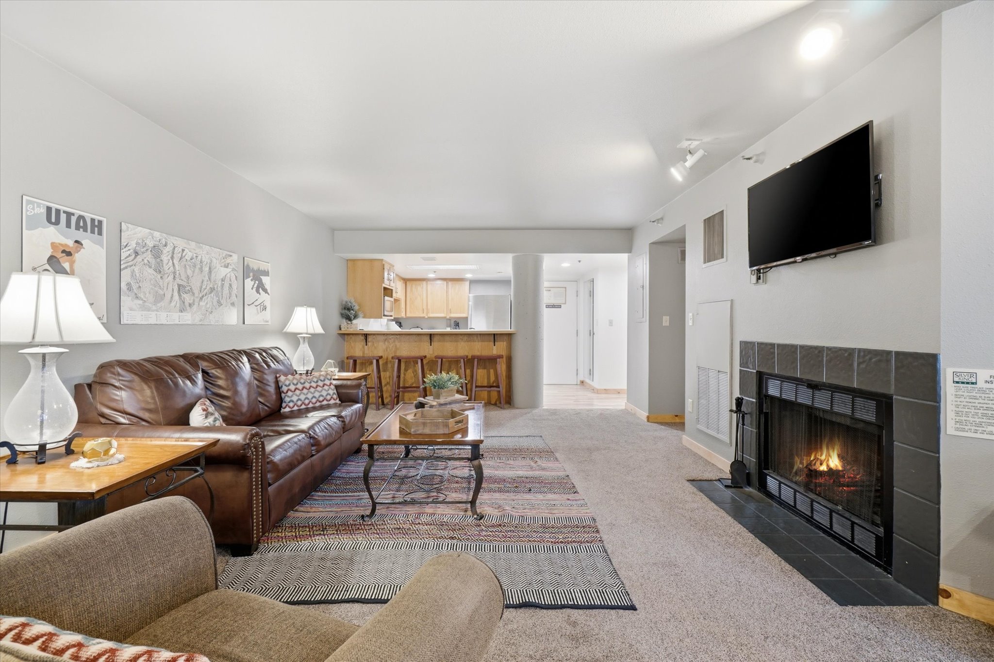 Open-concept living area with neutral wall tones and recessed lighting