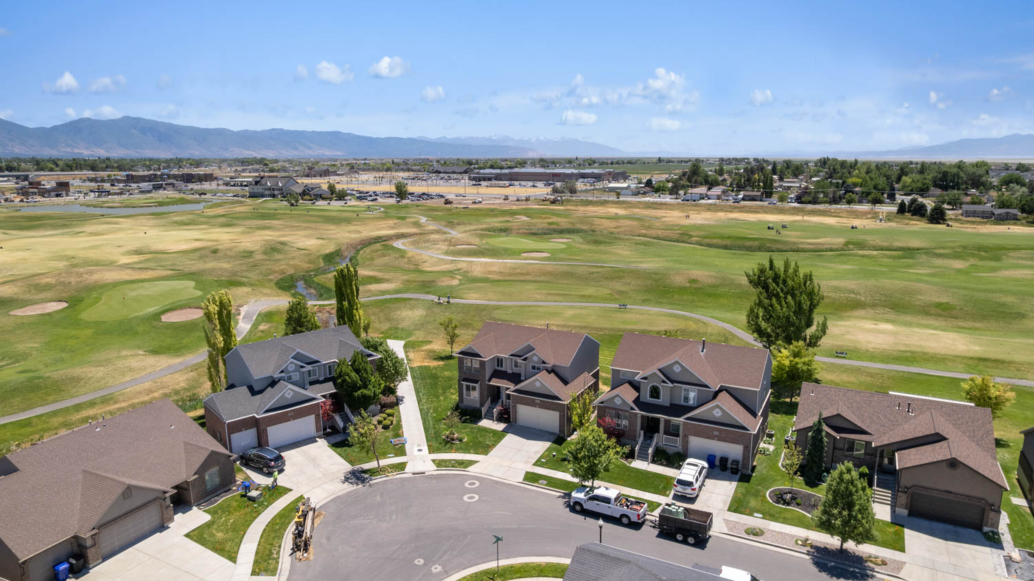 Aerial perspective showcasing a residential cul-de-sac with manicured lawns and mature landscaping
