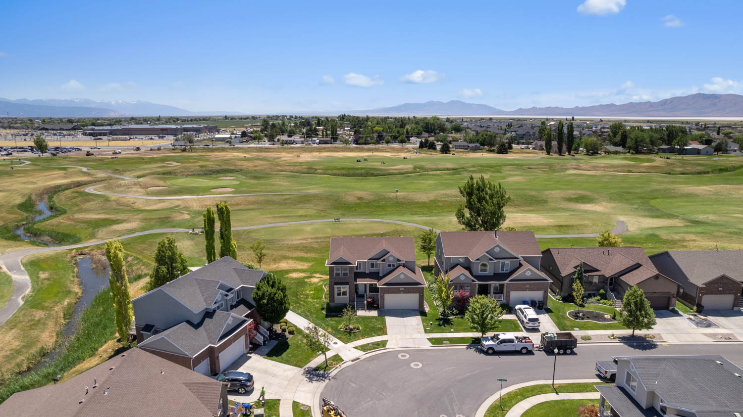 Aerial perspective showcasing residential properties bordering a golf course