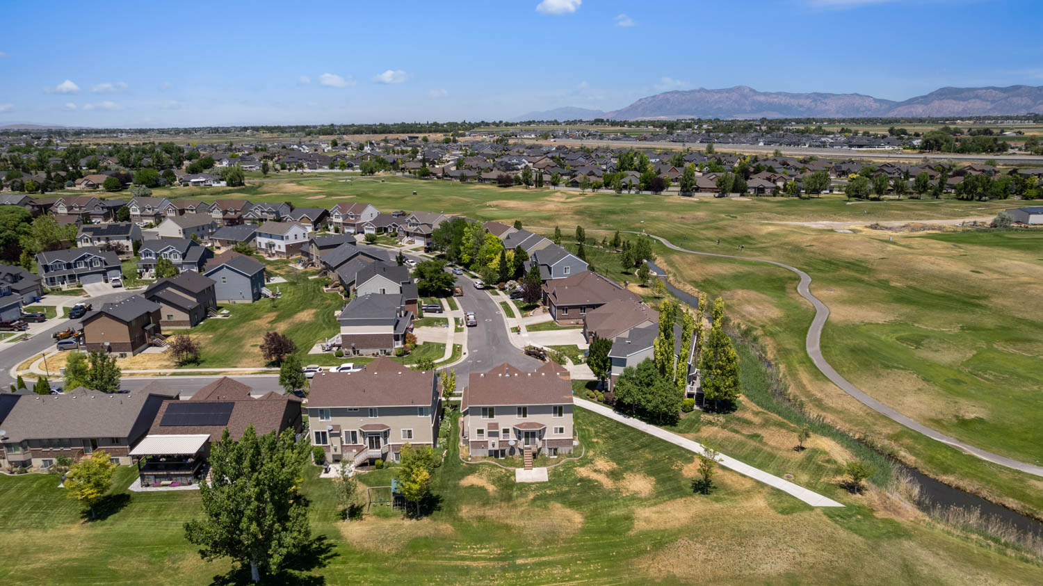 Residential neighborhood featuring a curvilinear street layout and varied home designs
