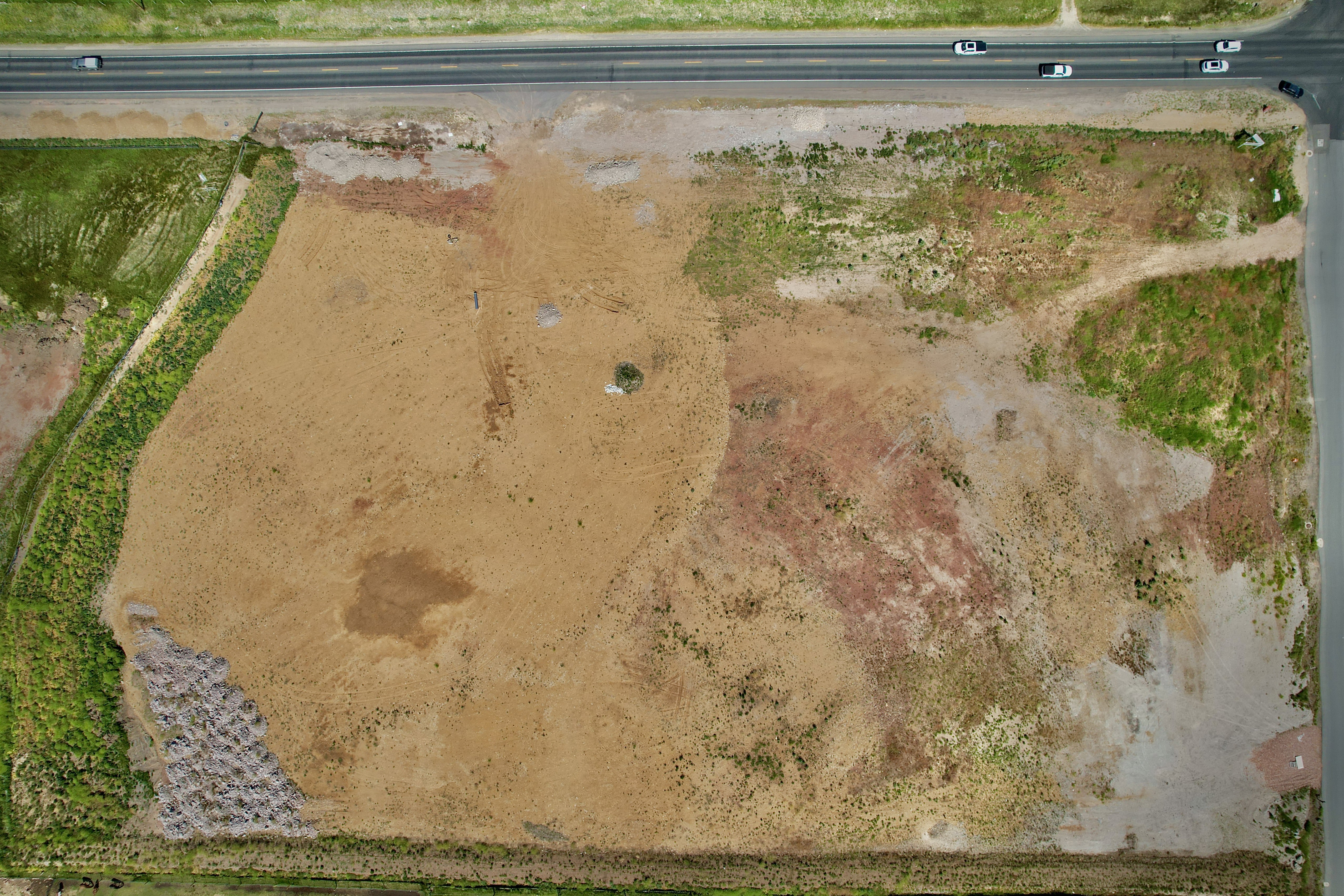 Expansive undeveloped land featuring varied terrain and direct road frontage