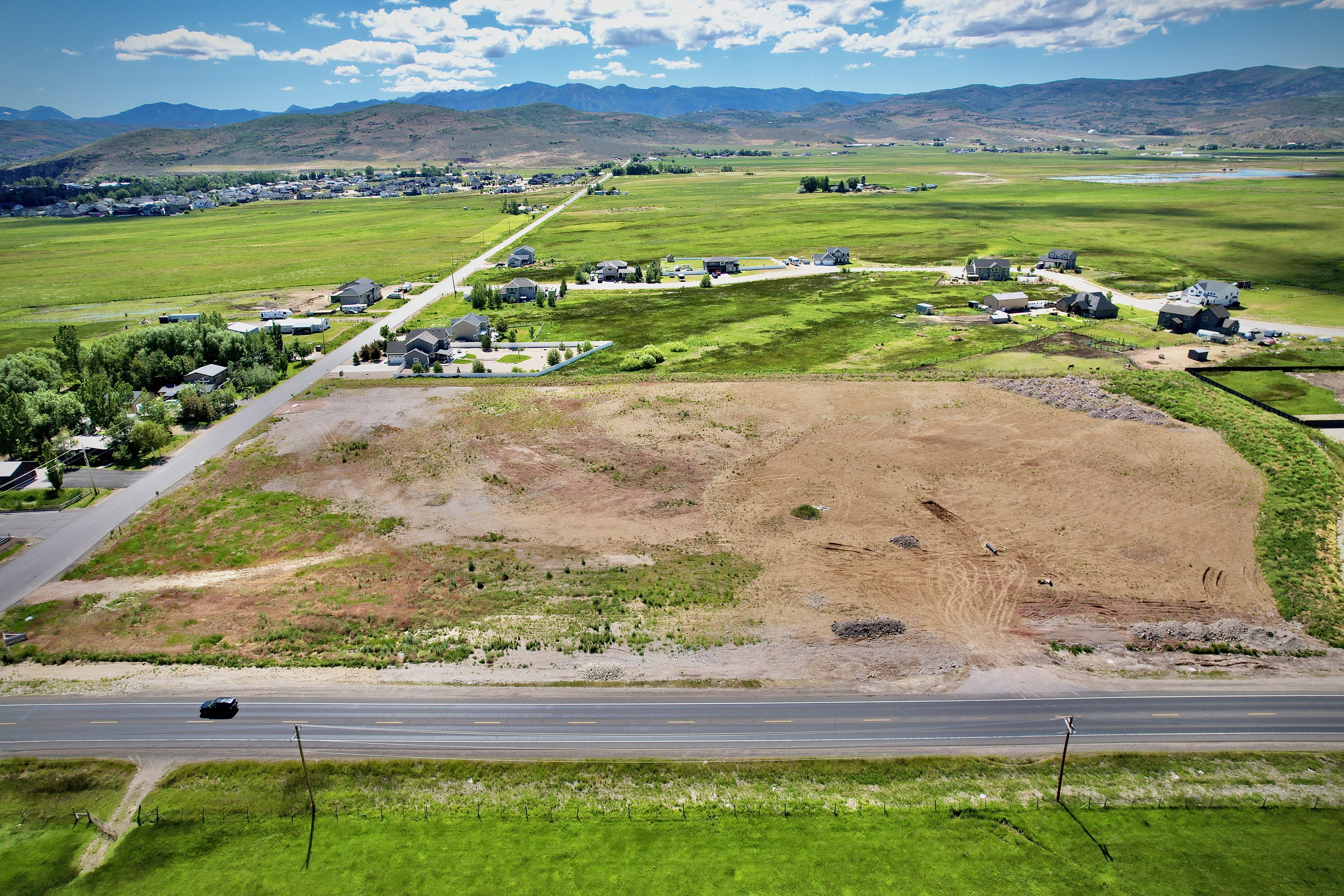 Expansive land parcel featuring direct road frontage and mountain scenery
