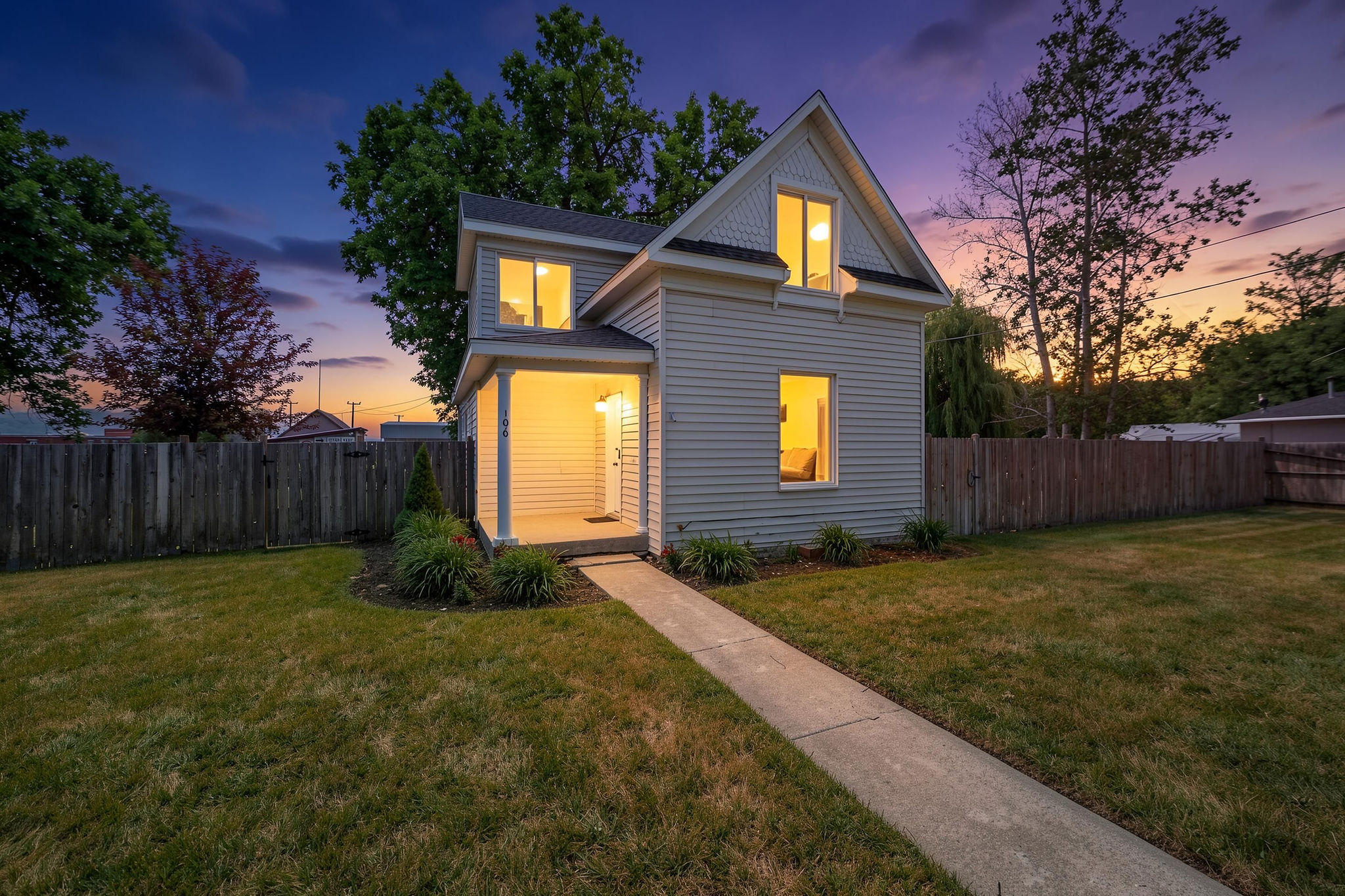 Two-story residence featuring horizontal siding and an inviting covered porch