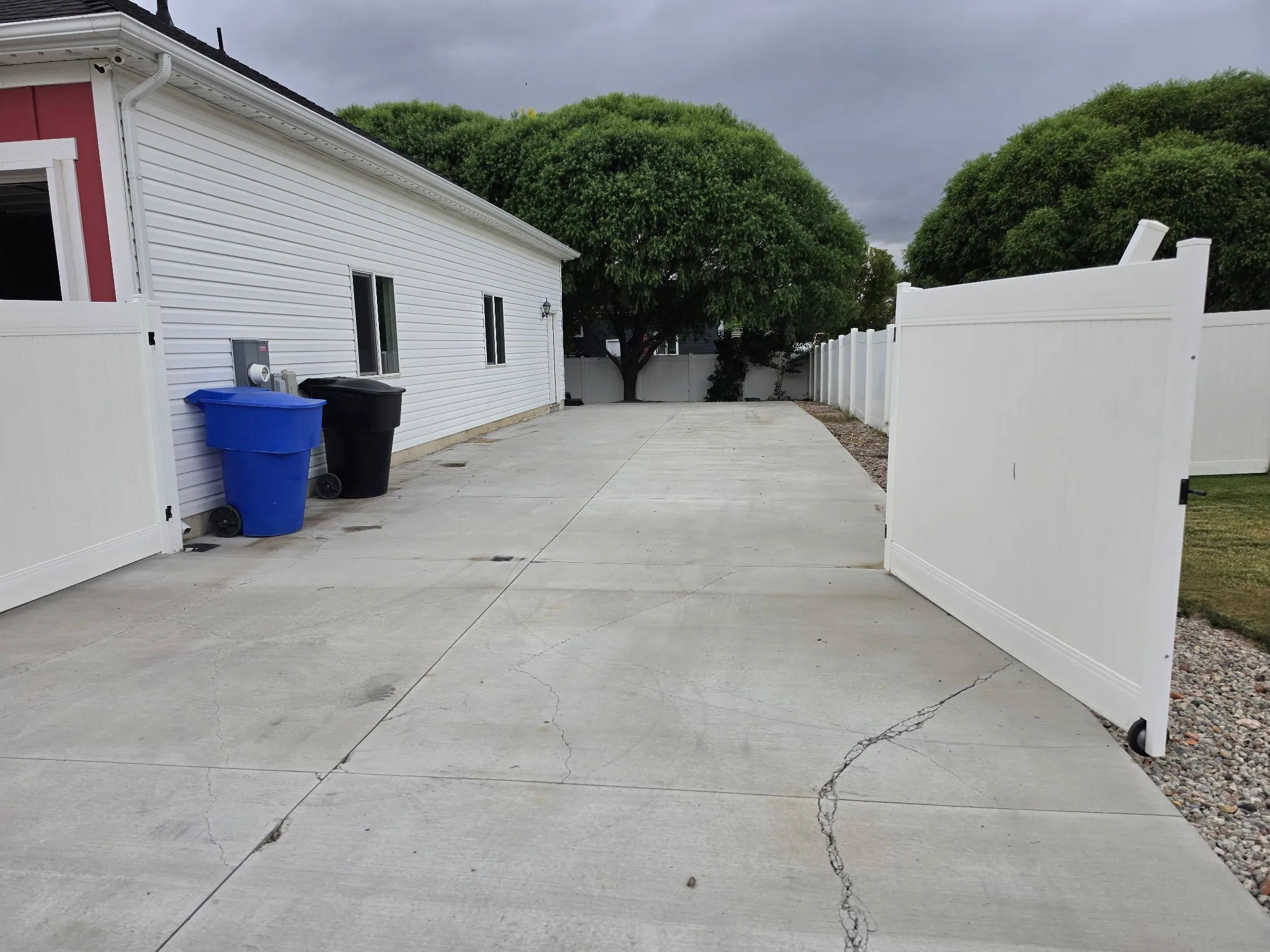 Concrete driveway with a vinyl fence