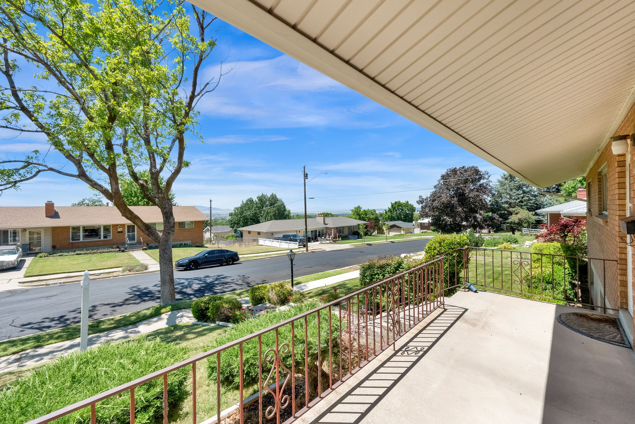 Covered front porch with railing.