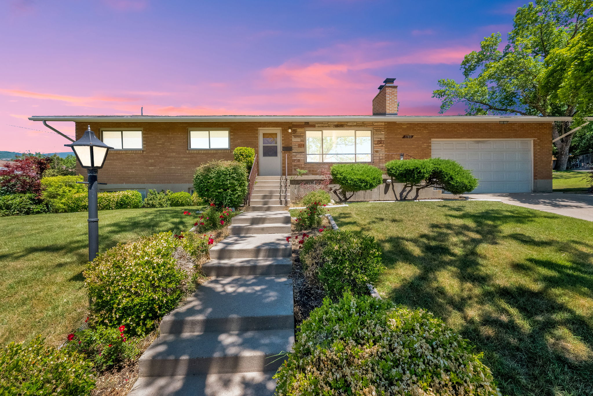 Brick exterior residence featuring a front entry