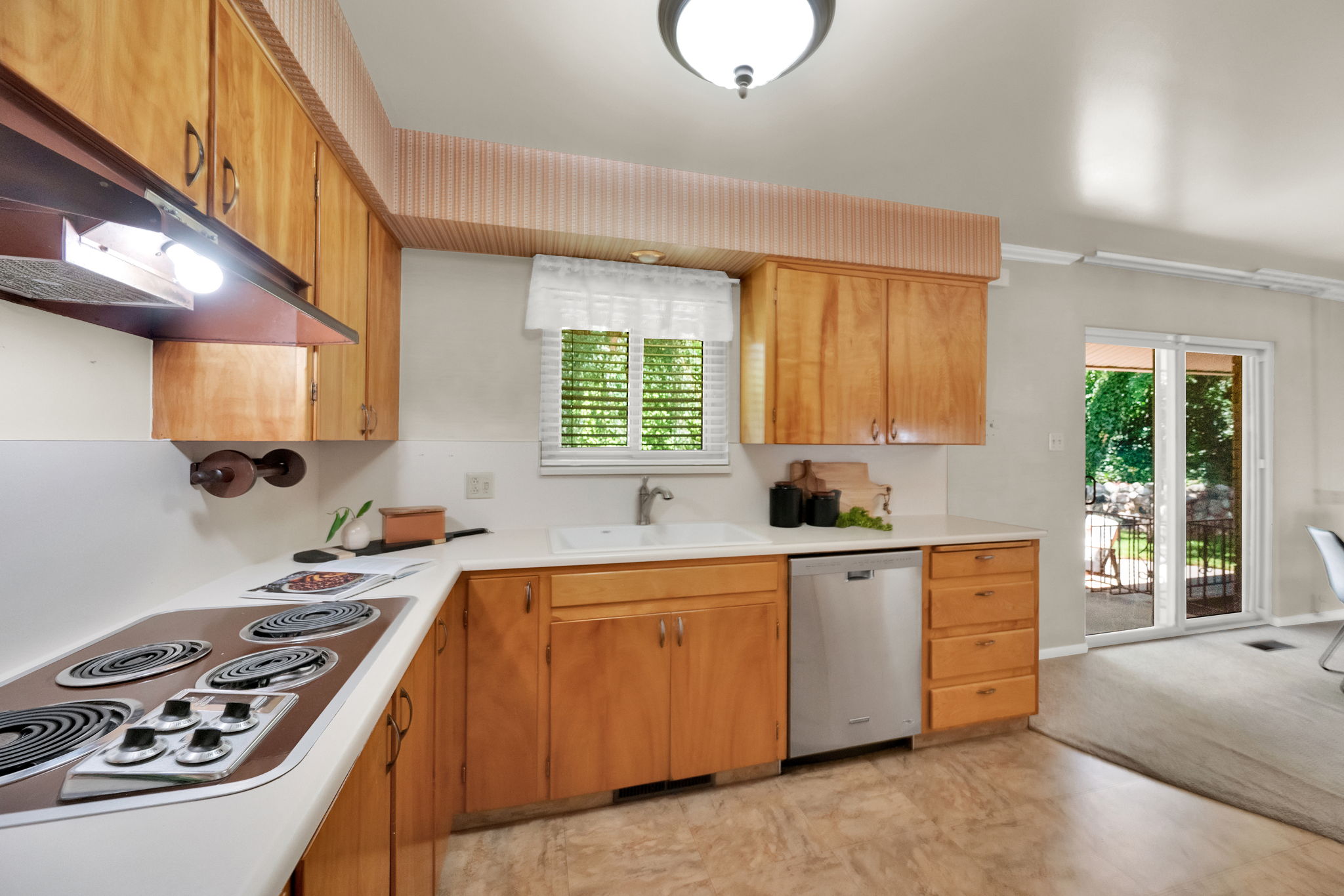 Kitchen featuring built-in cooktop, and a stainless steel dishwasher