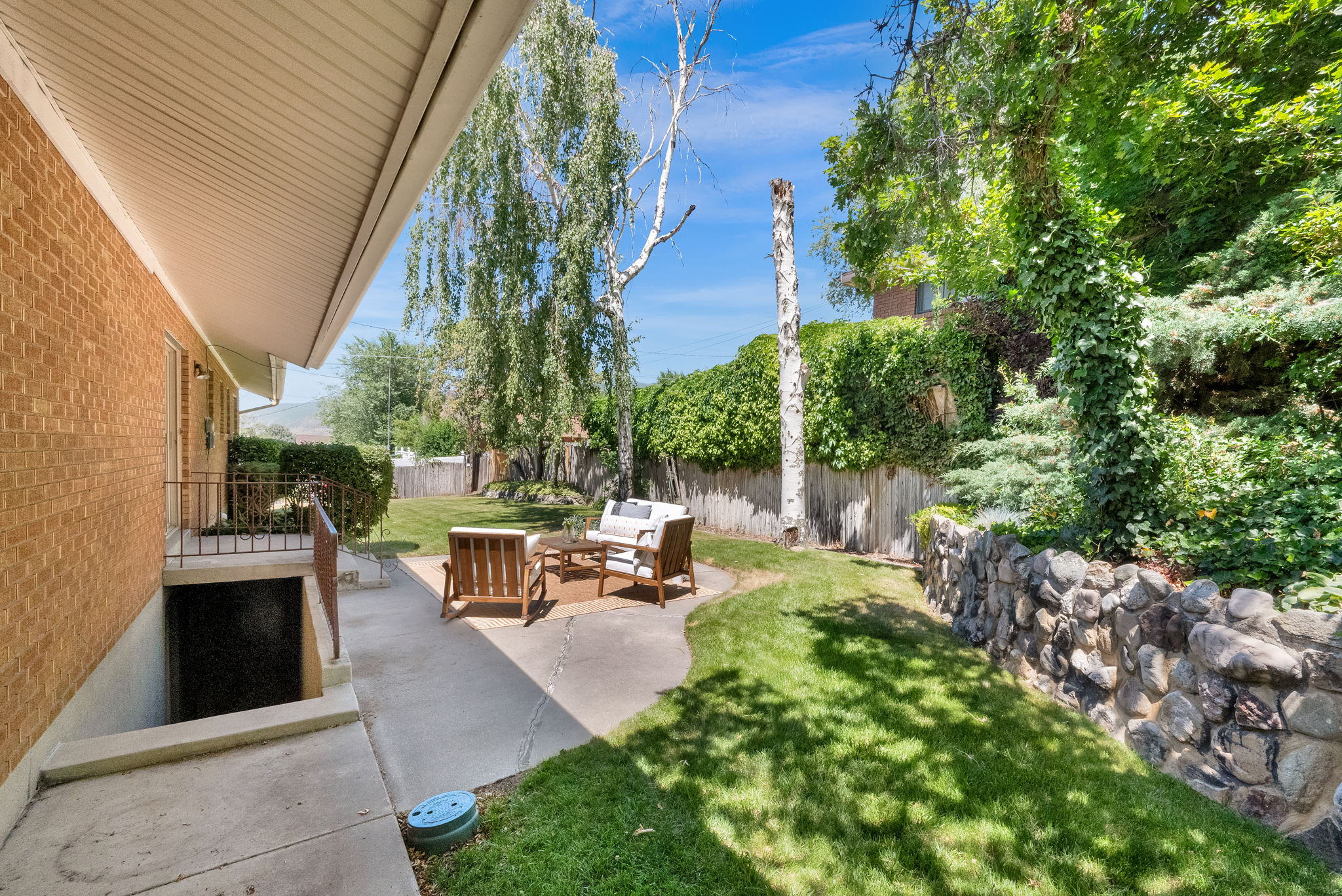 Concrete patio, and a stone retaining wall