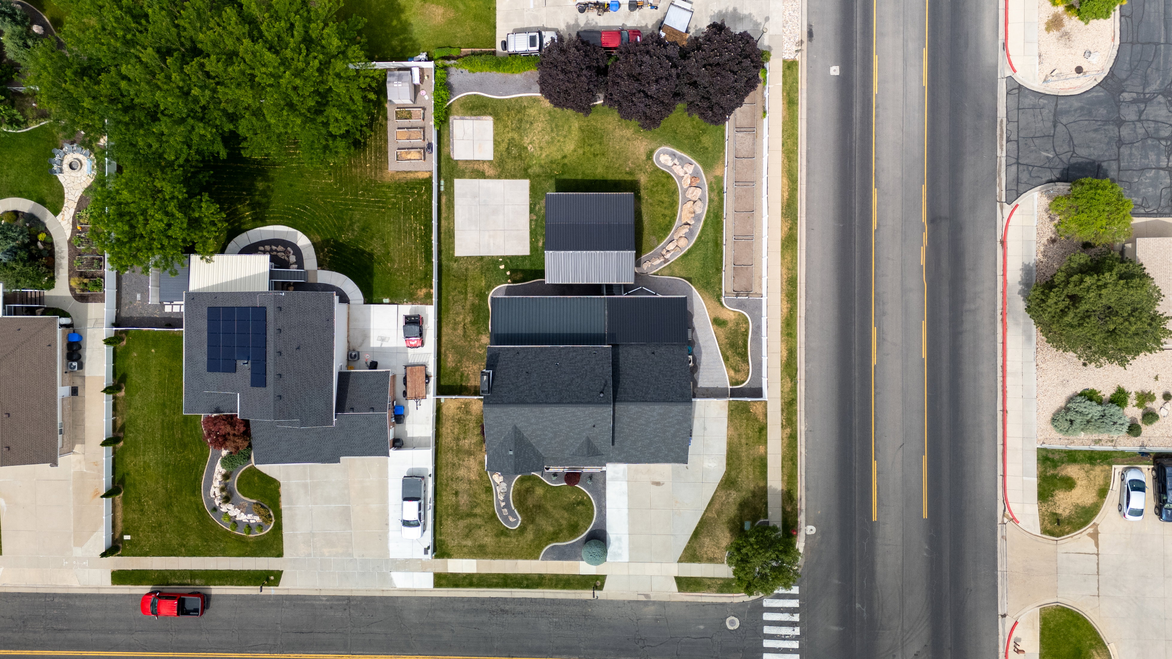 Aerial perspective showcasing the property and neighboring properties with structured landscaping