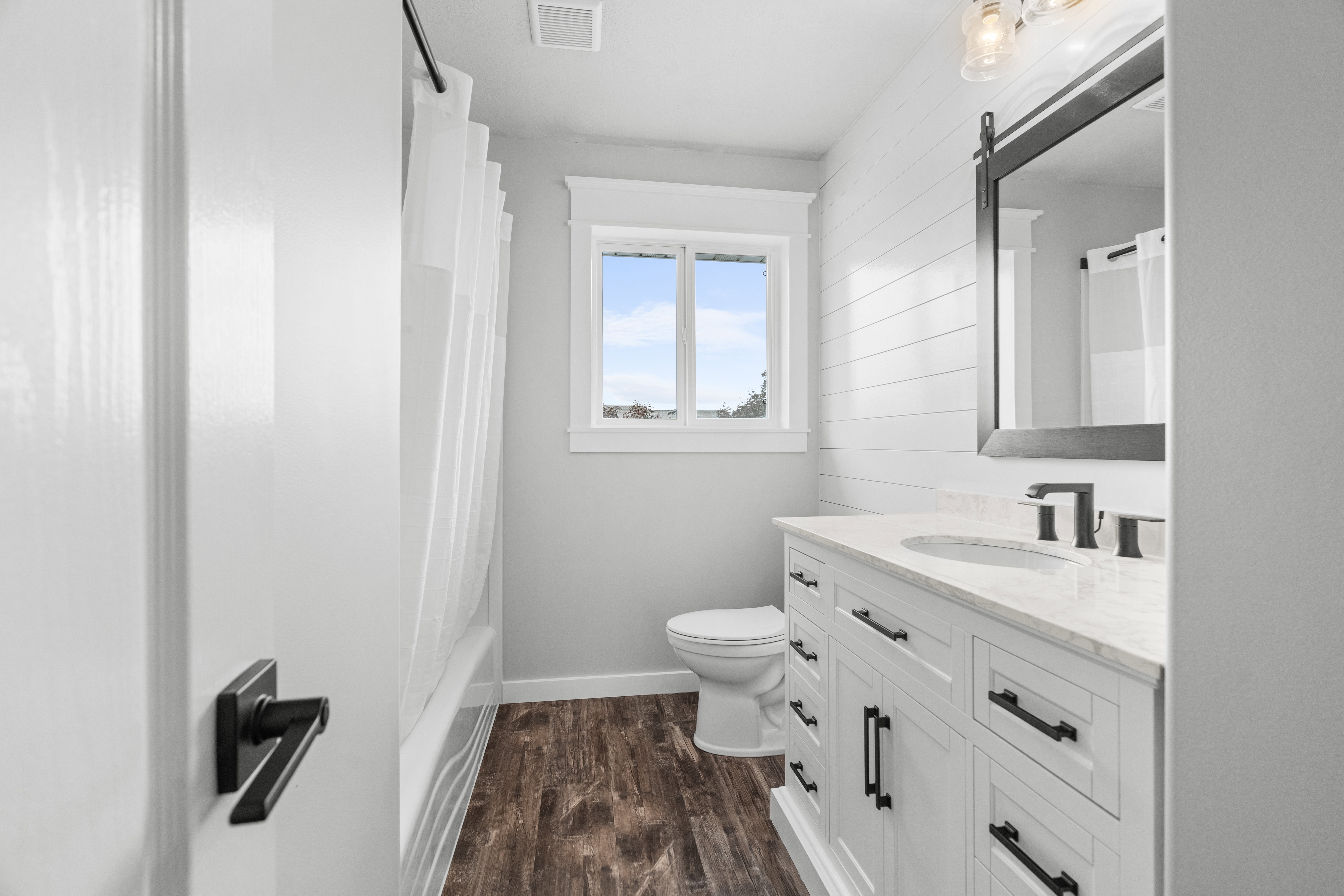 Upstairs bathroom featuring a white vanity with extensive storage, a white countertop, and a rectangular sink with a matte black faucet