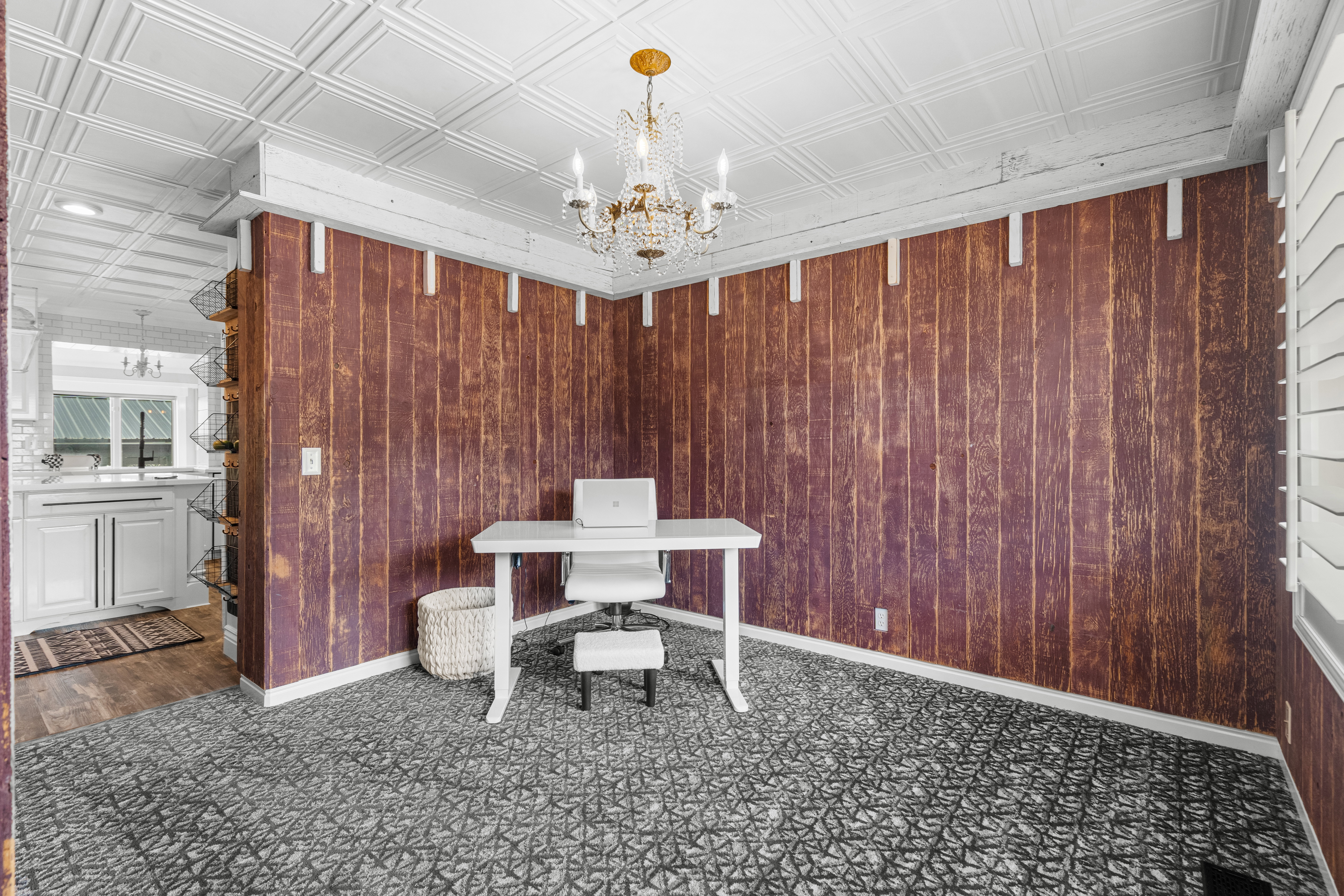 Charming office/breakfast nook highlighted by a designer paneled accent wall, decorative ceiling details, and stylish finishes that add character and functionality
