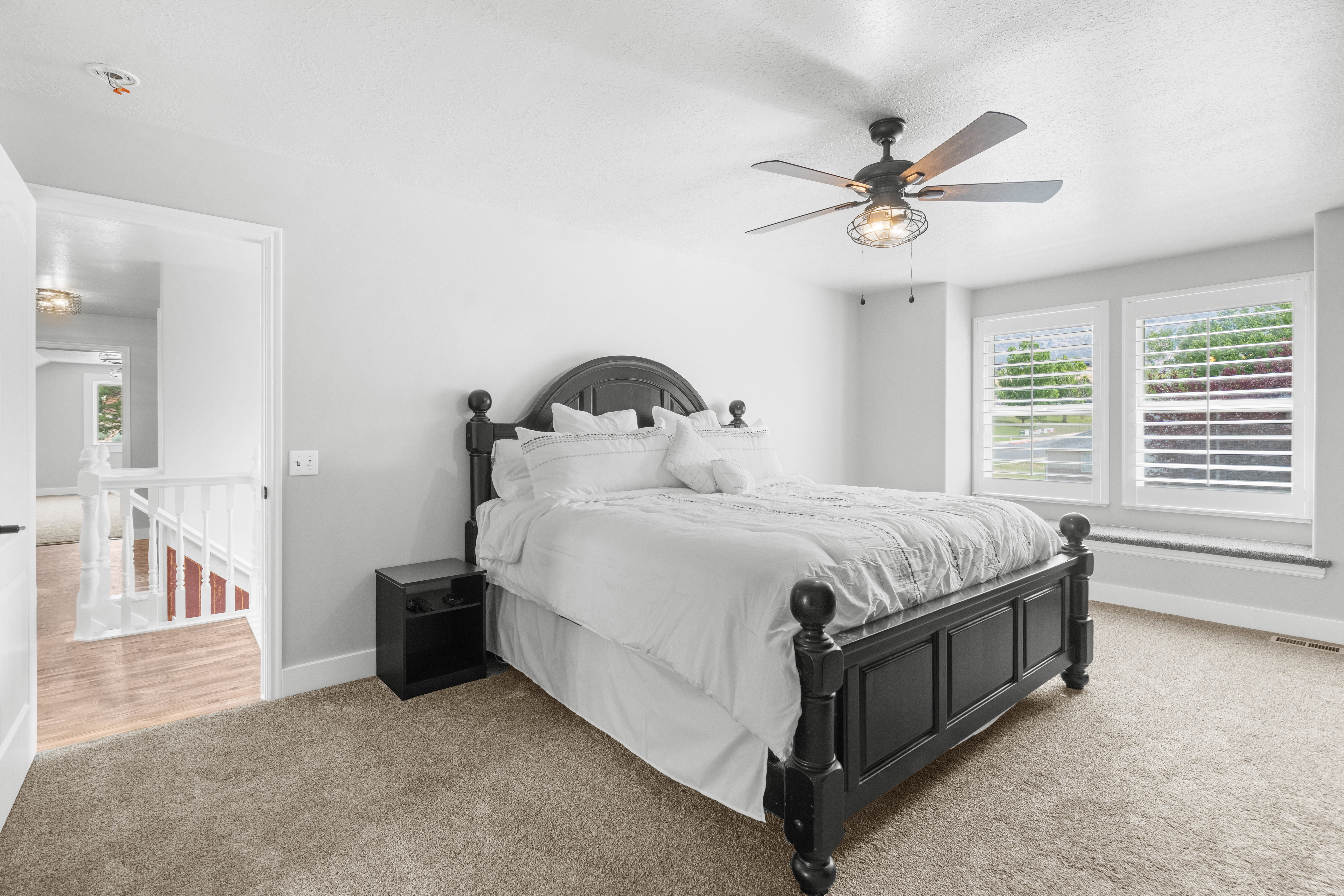 Primary bedroom with plush new carpeting and light gray neutral wall new tone paint