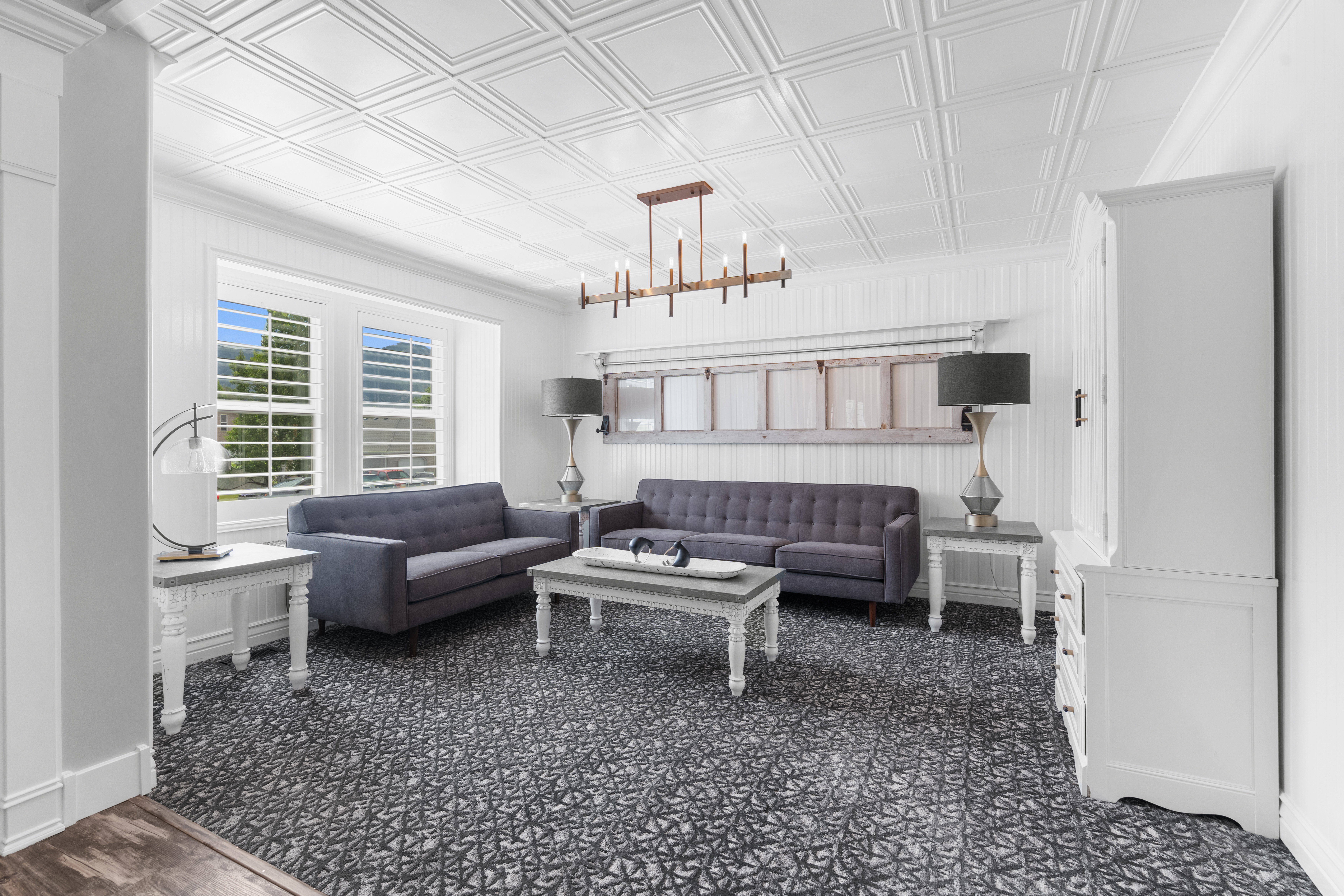 Formal living room off entry, white coffered ceiling with a linear chandelier