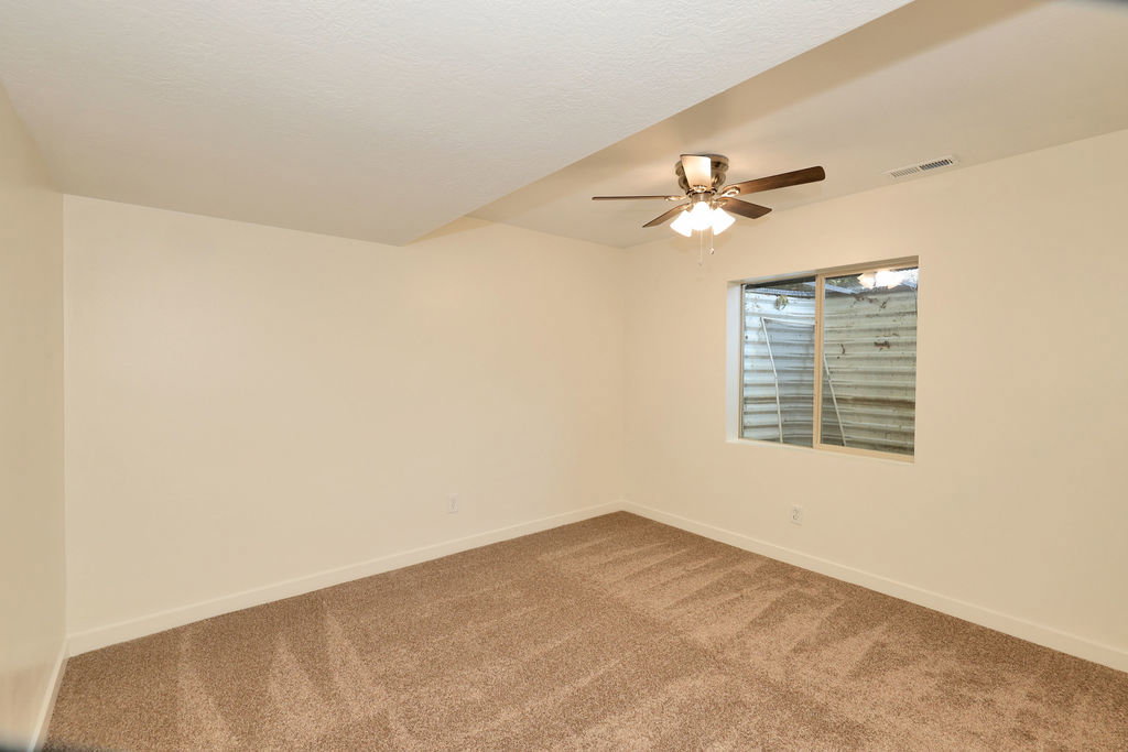 Room featuring neutral wall finishes and plush carpeting