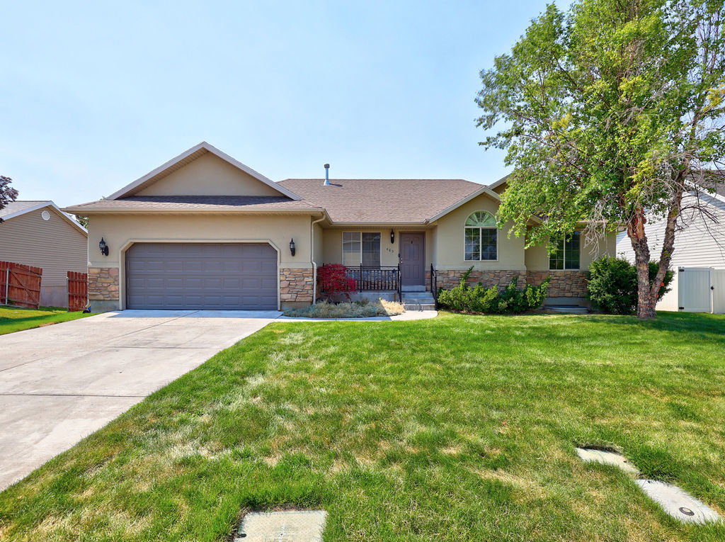 Ranch-style exterior with a stucco finish and stone accents