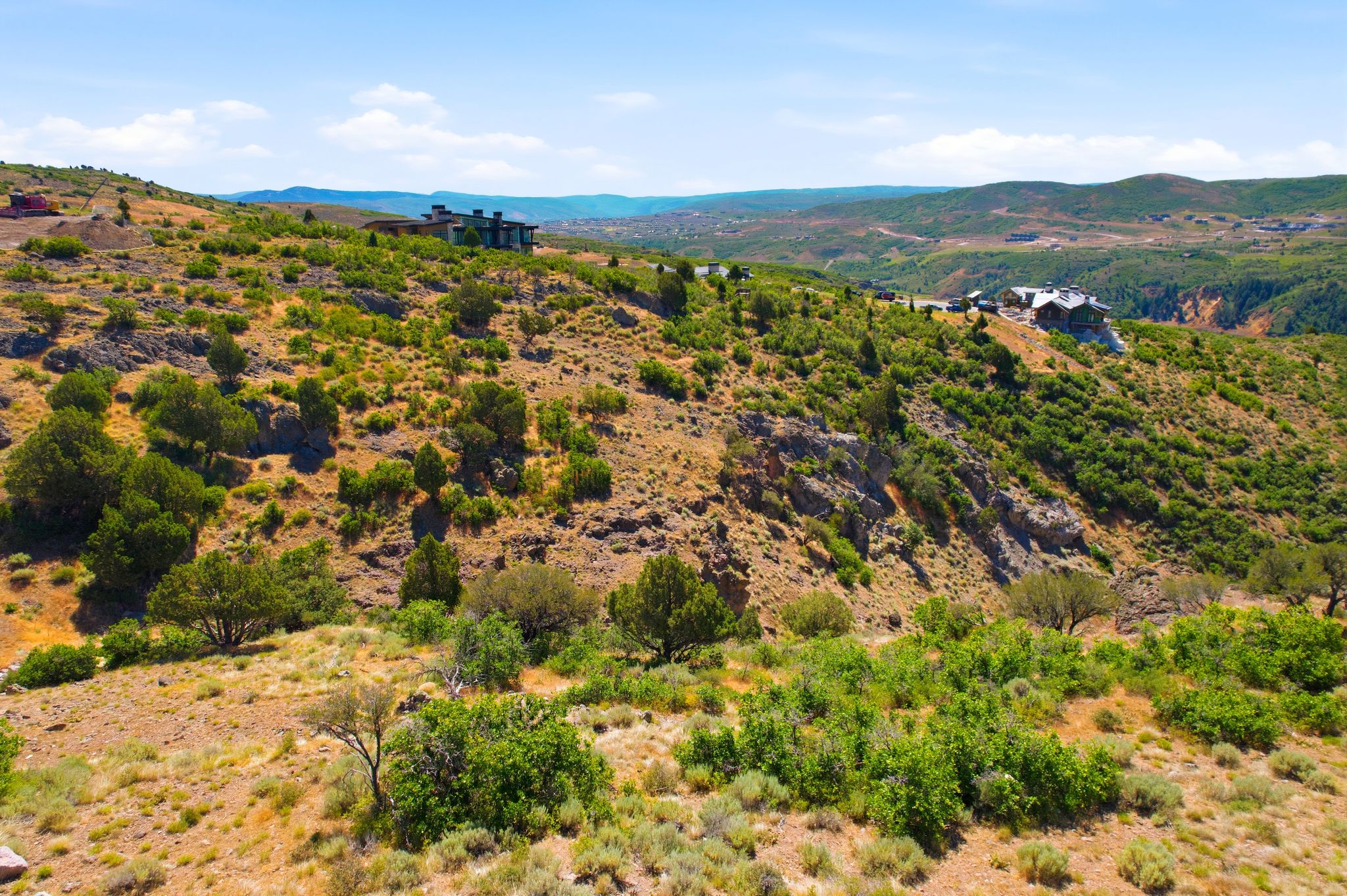Expansive hillside lot featuring natural rock formations and varied shrubbery