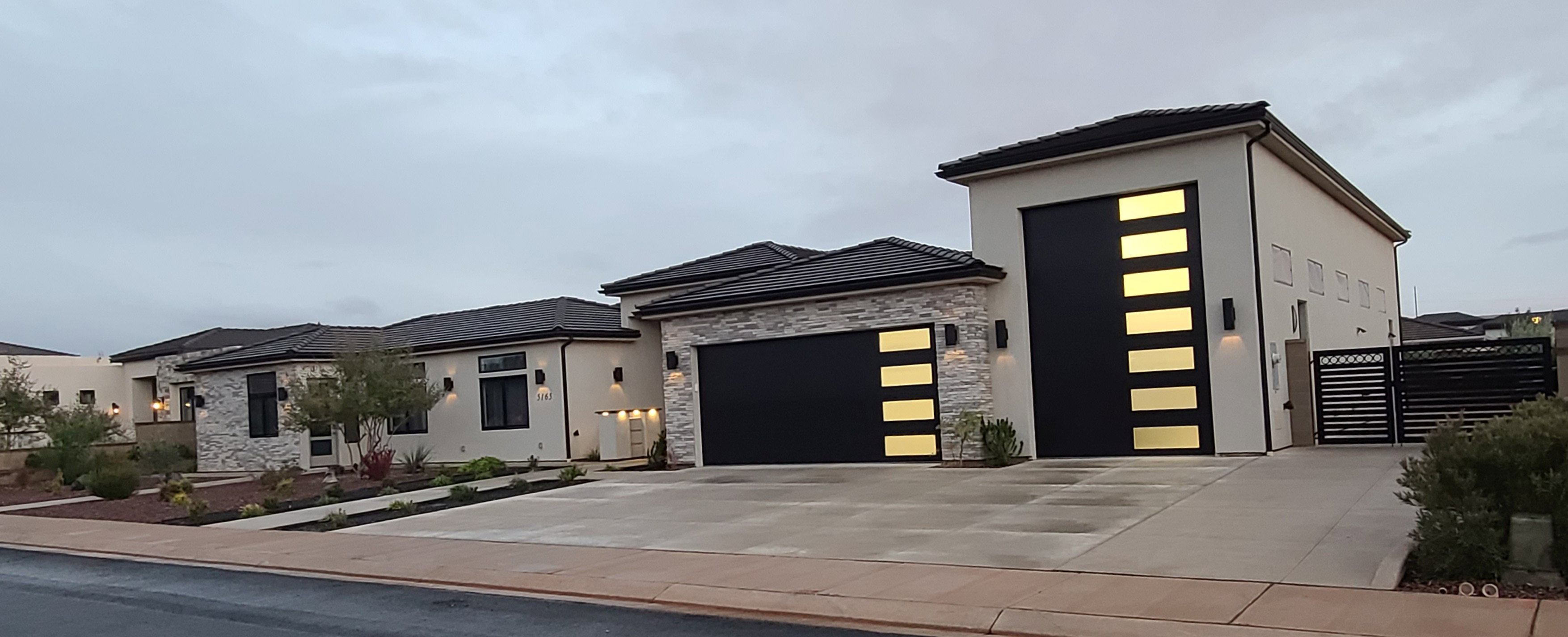 Modern architecture featuring a smooth stucco exterior with stacked stone accents