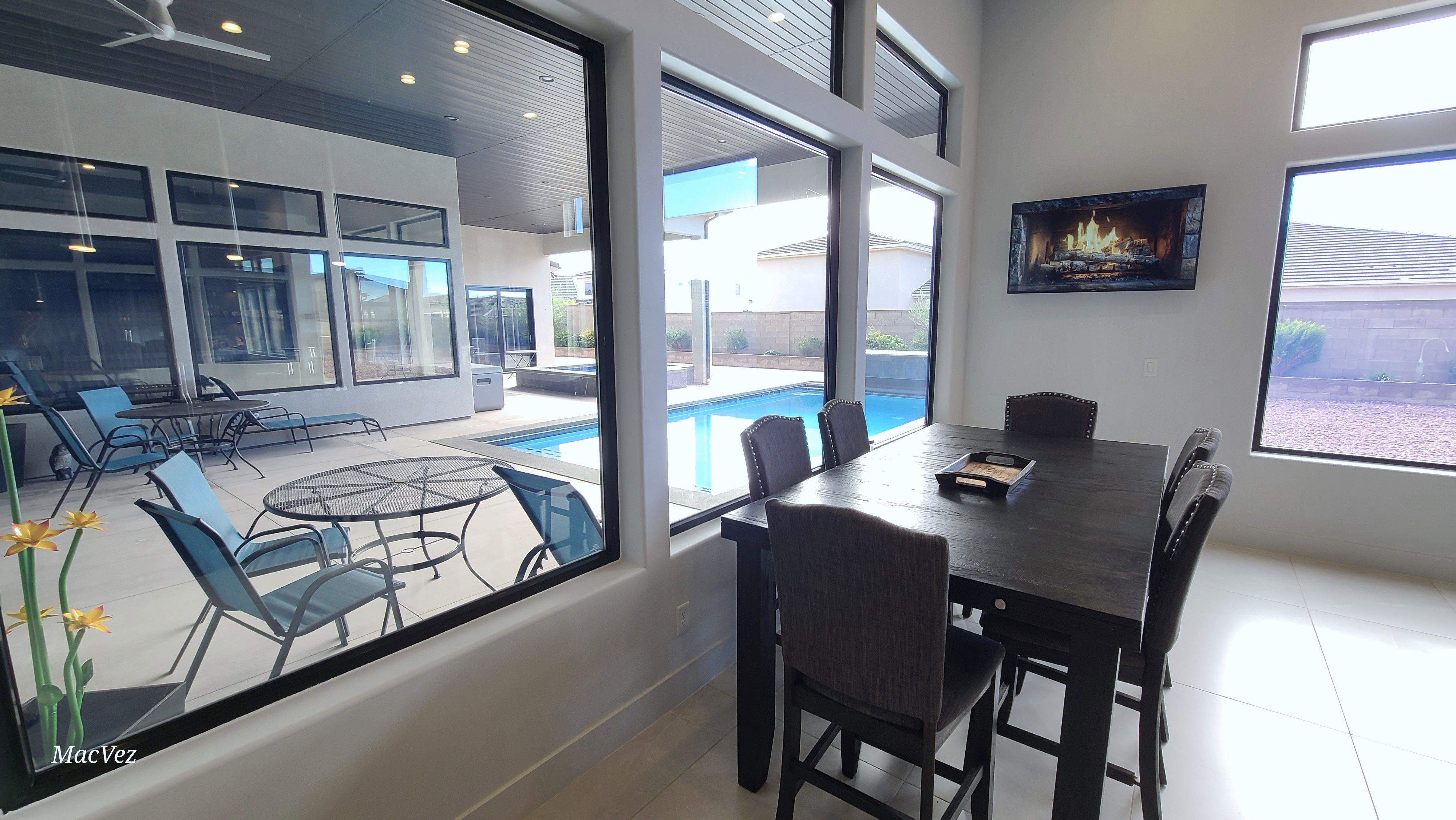 Interior dining area featuring light-toned flooring and expansive windows