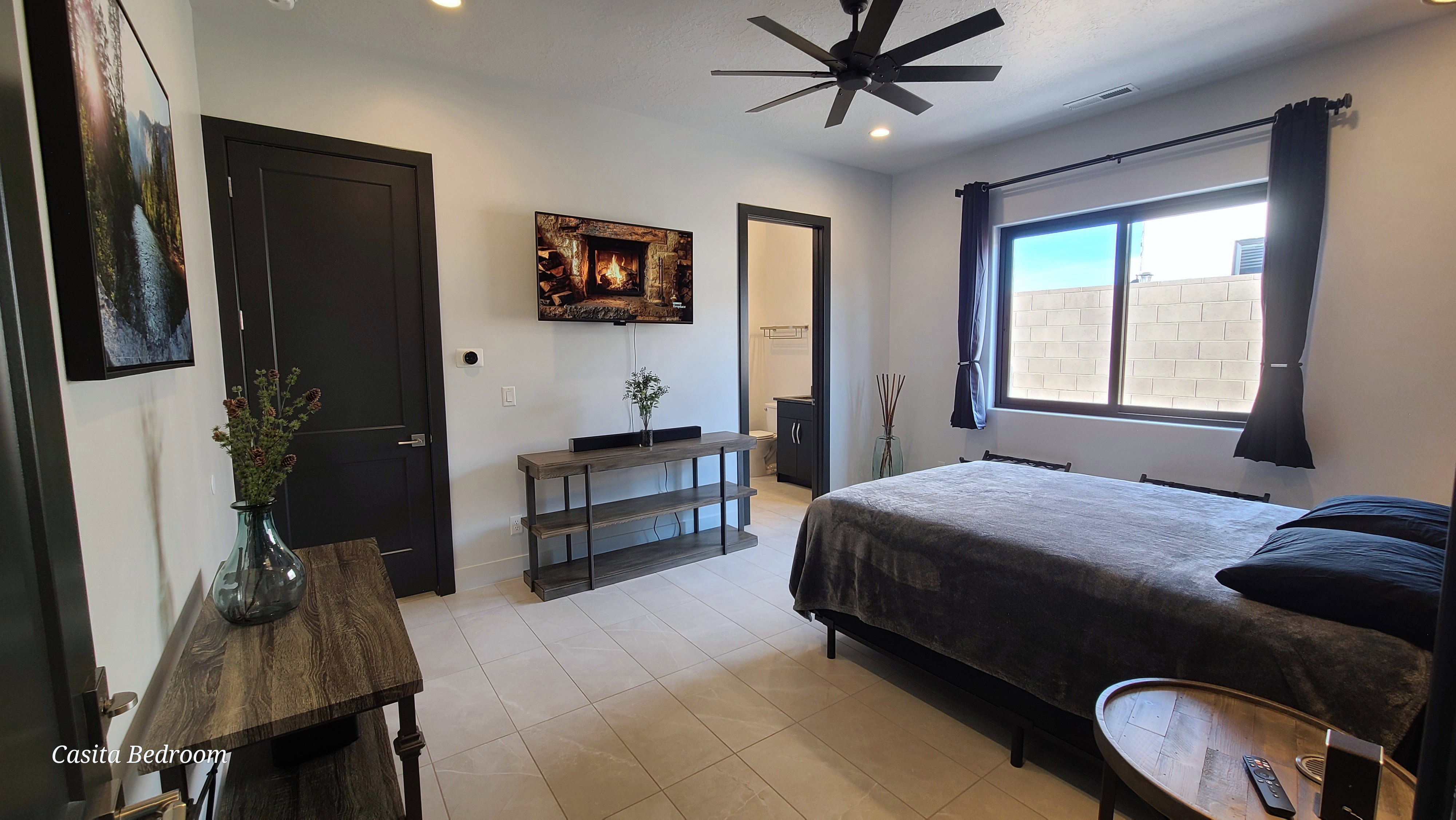 Spacious room featuring tile flooring, a large window, a ceiling fan with integrated lighting, and recessed ceiling lights
