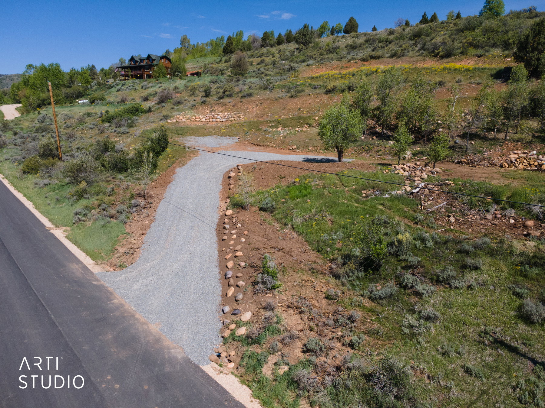 Gravel driveway extending from paved road