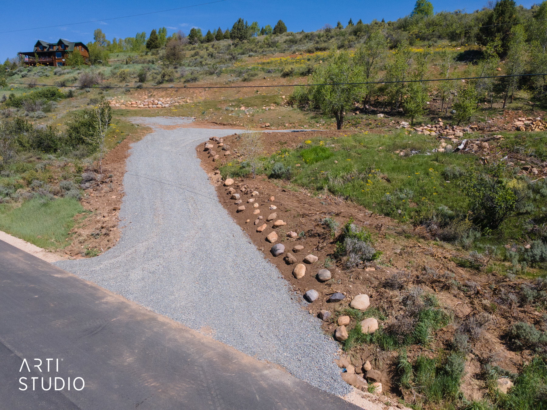 Gravel driveway extending from paved road