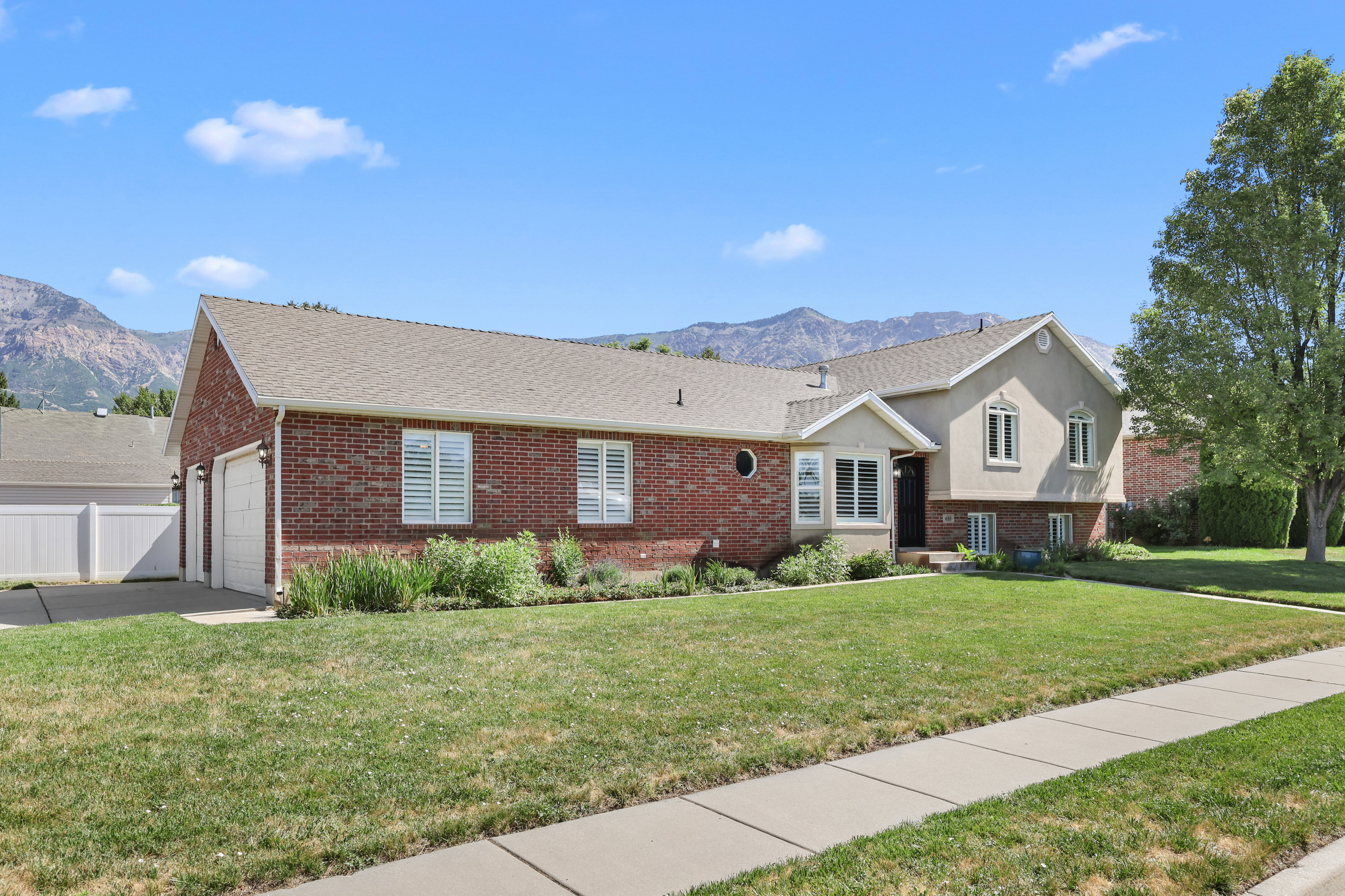 Brick and stucco exterior with a three-car garage