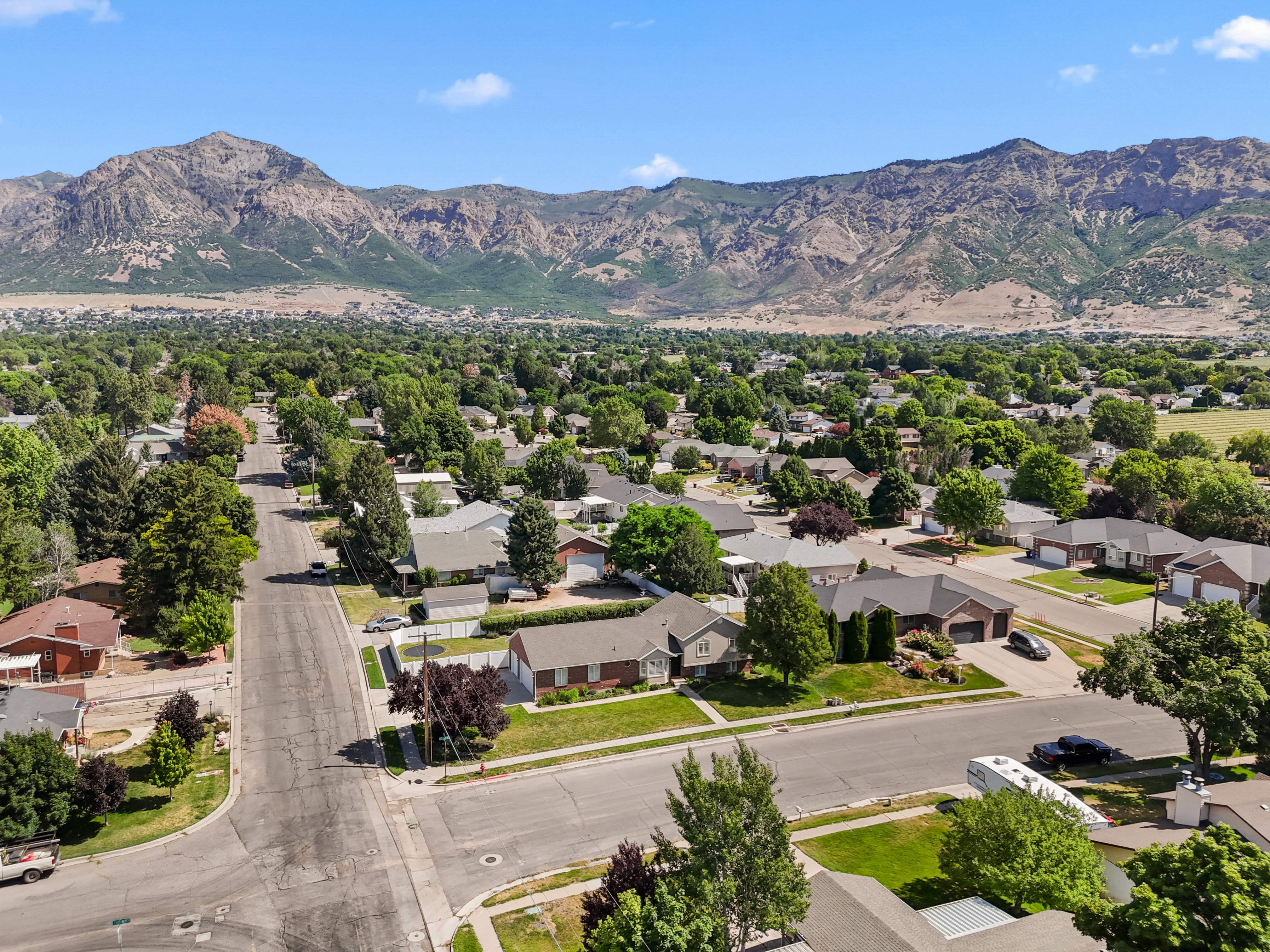 Expansive residential neighborhood featuring mature trees and a distant mountain backdrop