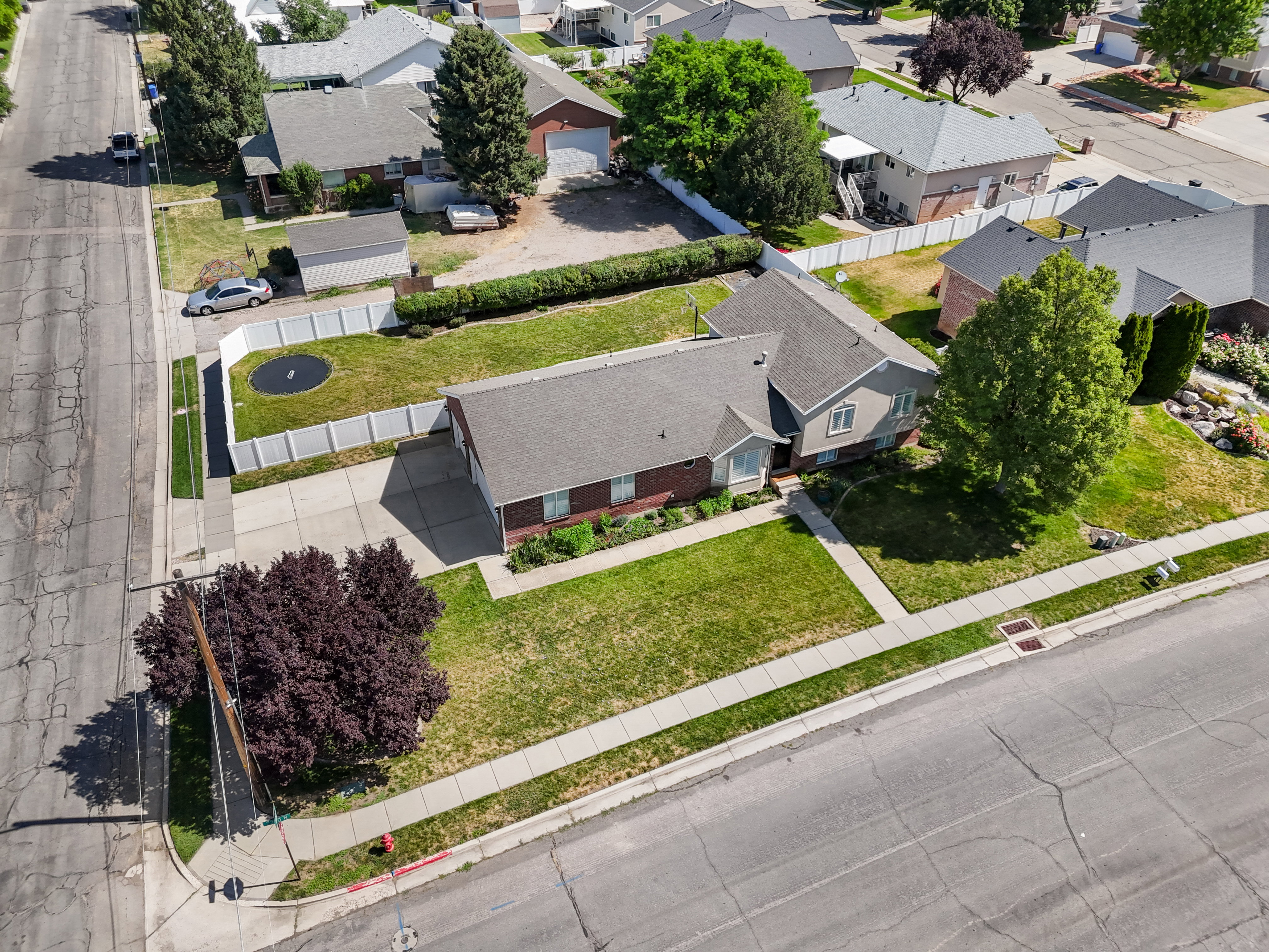 Single-family residence featuring a brick and siding exterior, a well-maintained lawn, and a paved driveway leading to a three-car garage