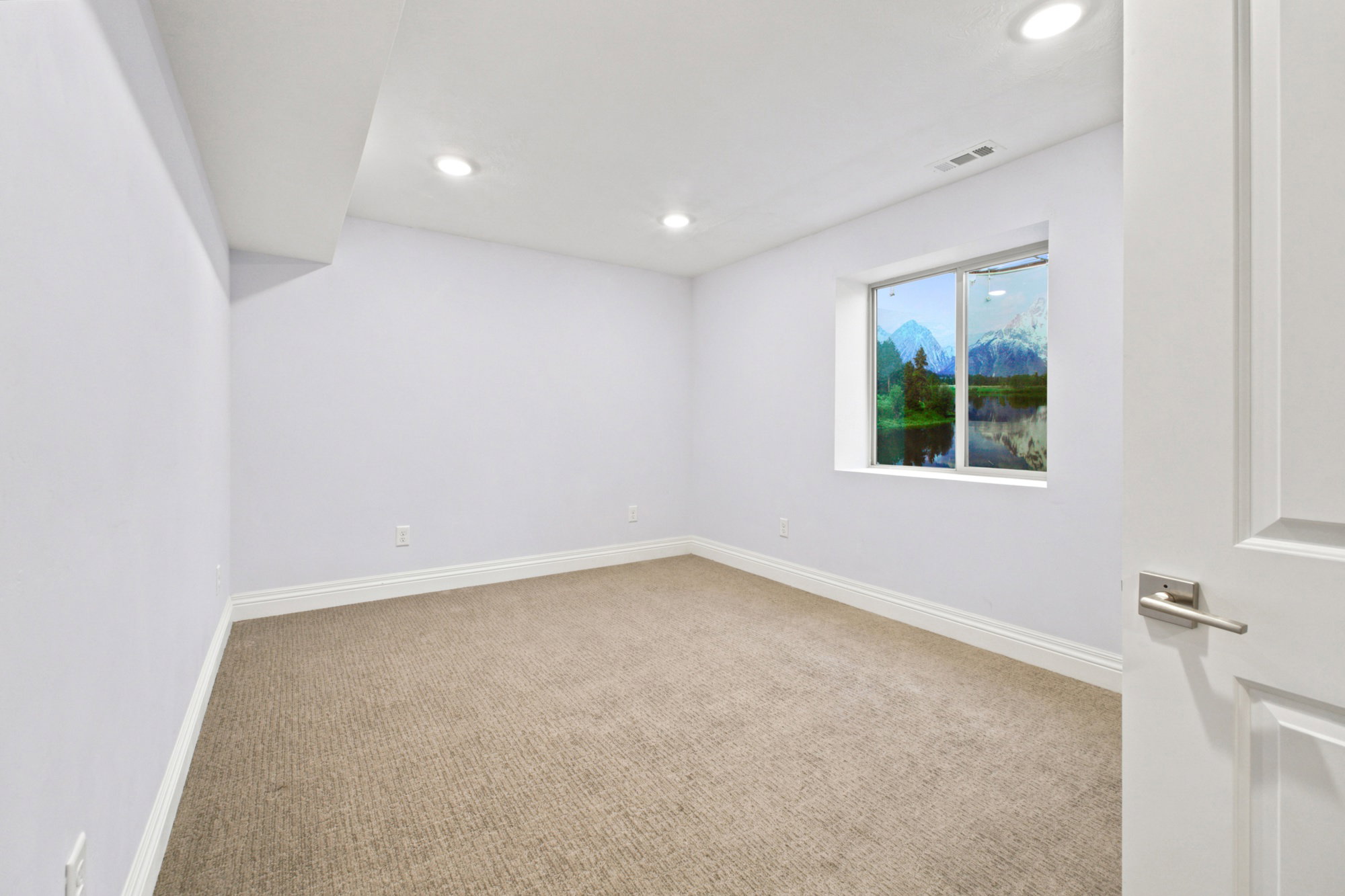 Room featuring light-toned carpeting, white baseboards, and recessed ceiling lighting