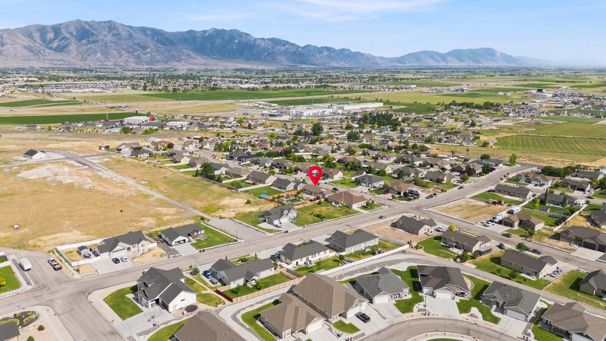 Expansive residential development featuring a mix of established homes set against a backdrop of distant mountains