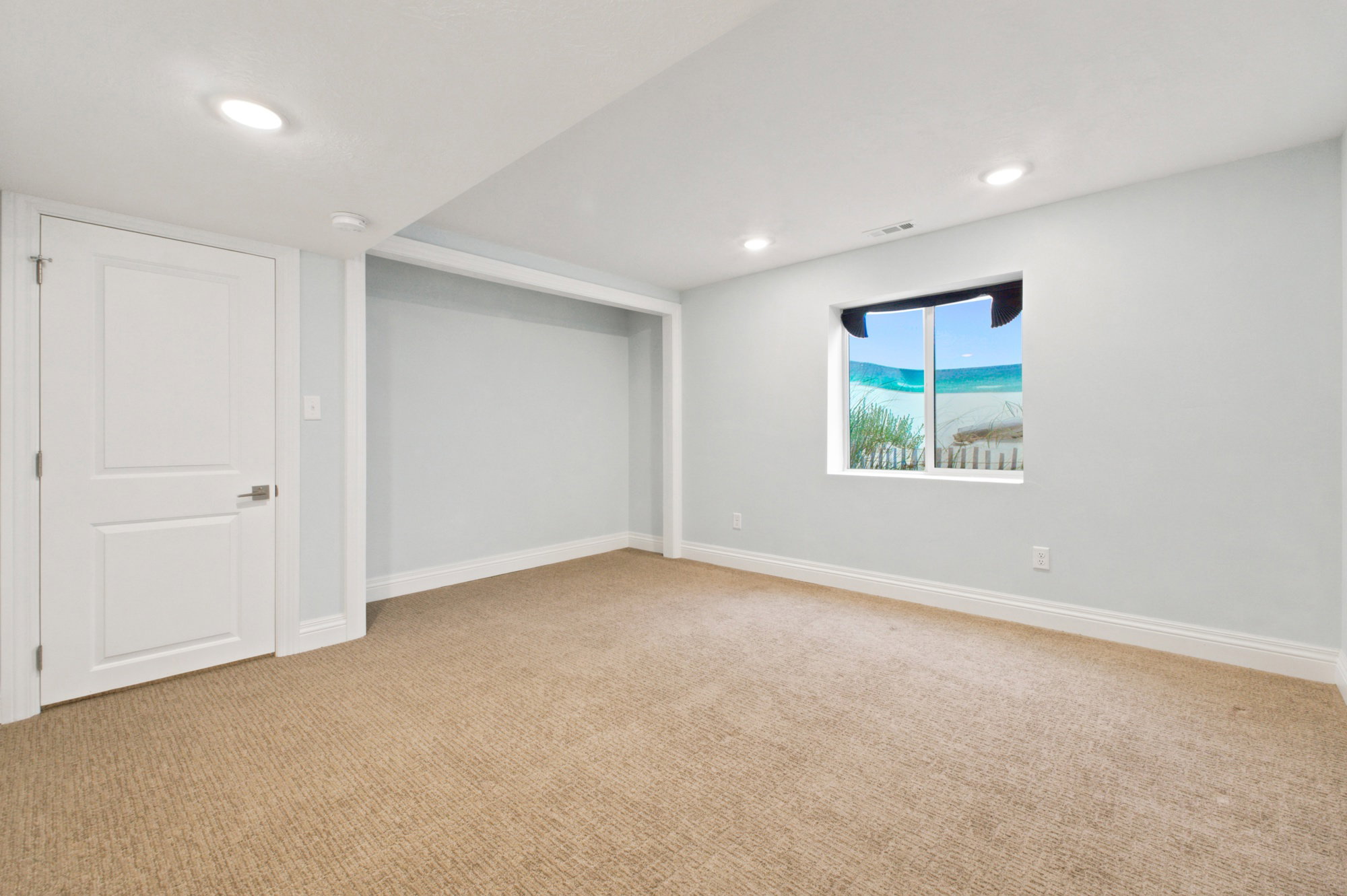 Light-colored carpeting complementing soft wall tones