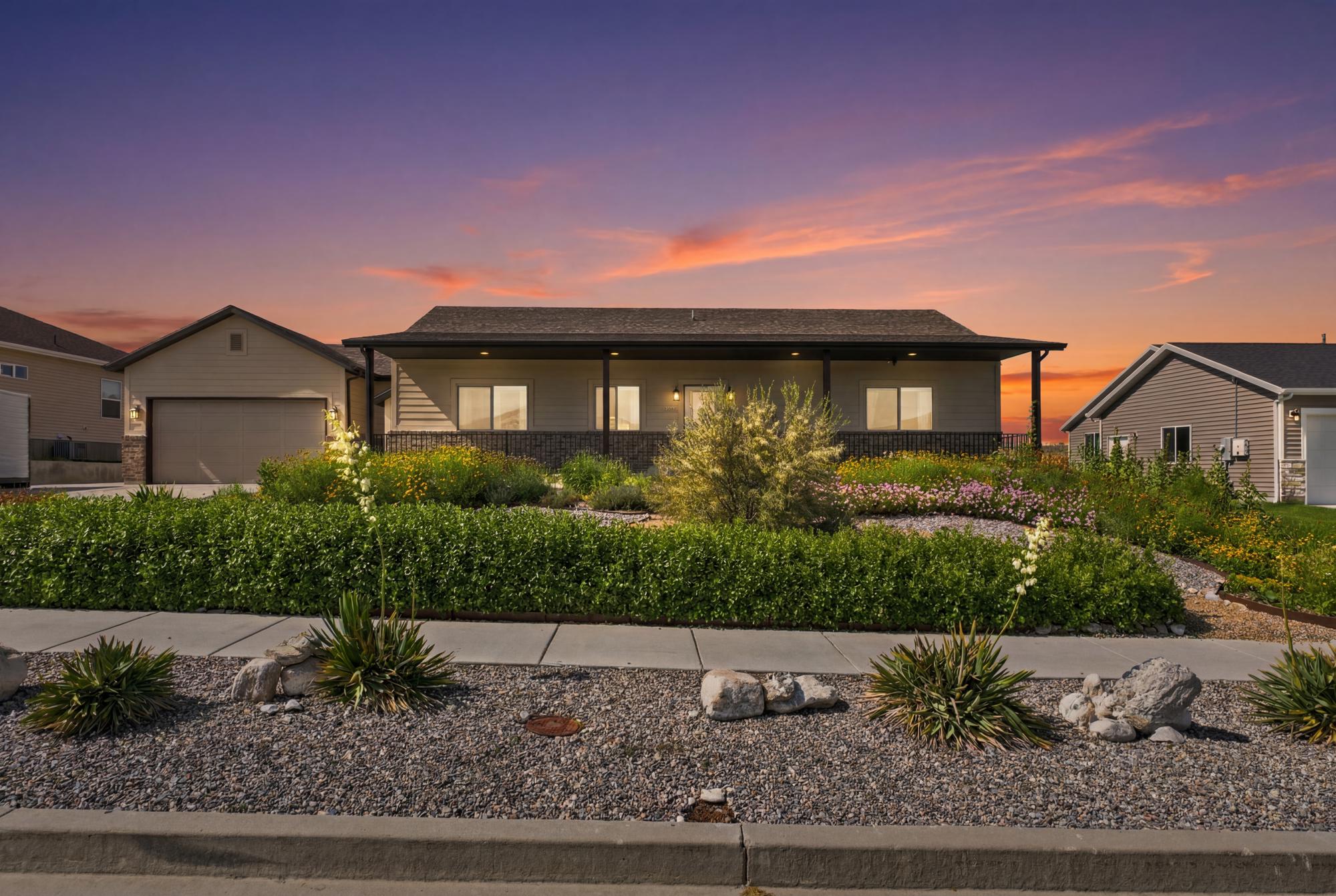 Ranch-style residence featuring a covered front porch and a two-car garage