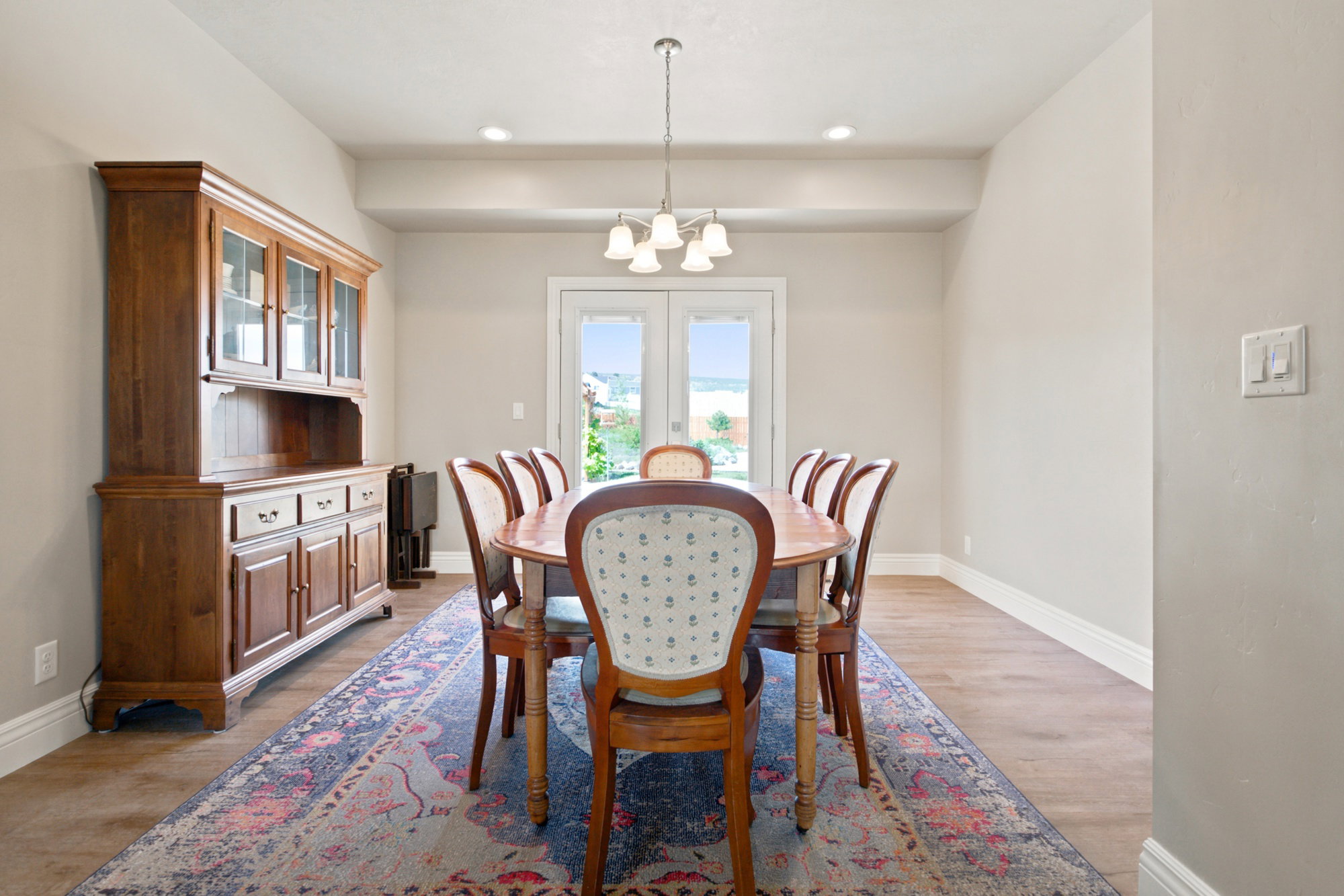 Dining area featuring wood-finish flooring, neutral wall paint, and white baseboards