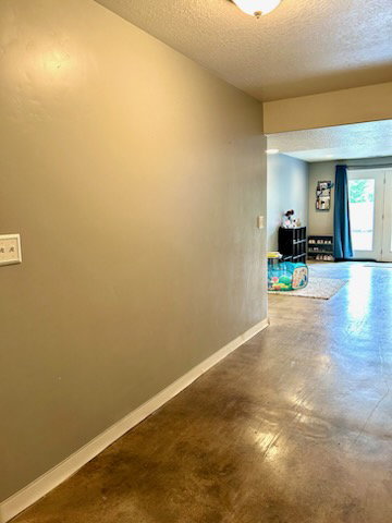 Light-colored interior walls with white baseboards and a ceiling-mounted light fixture