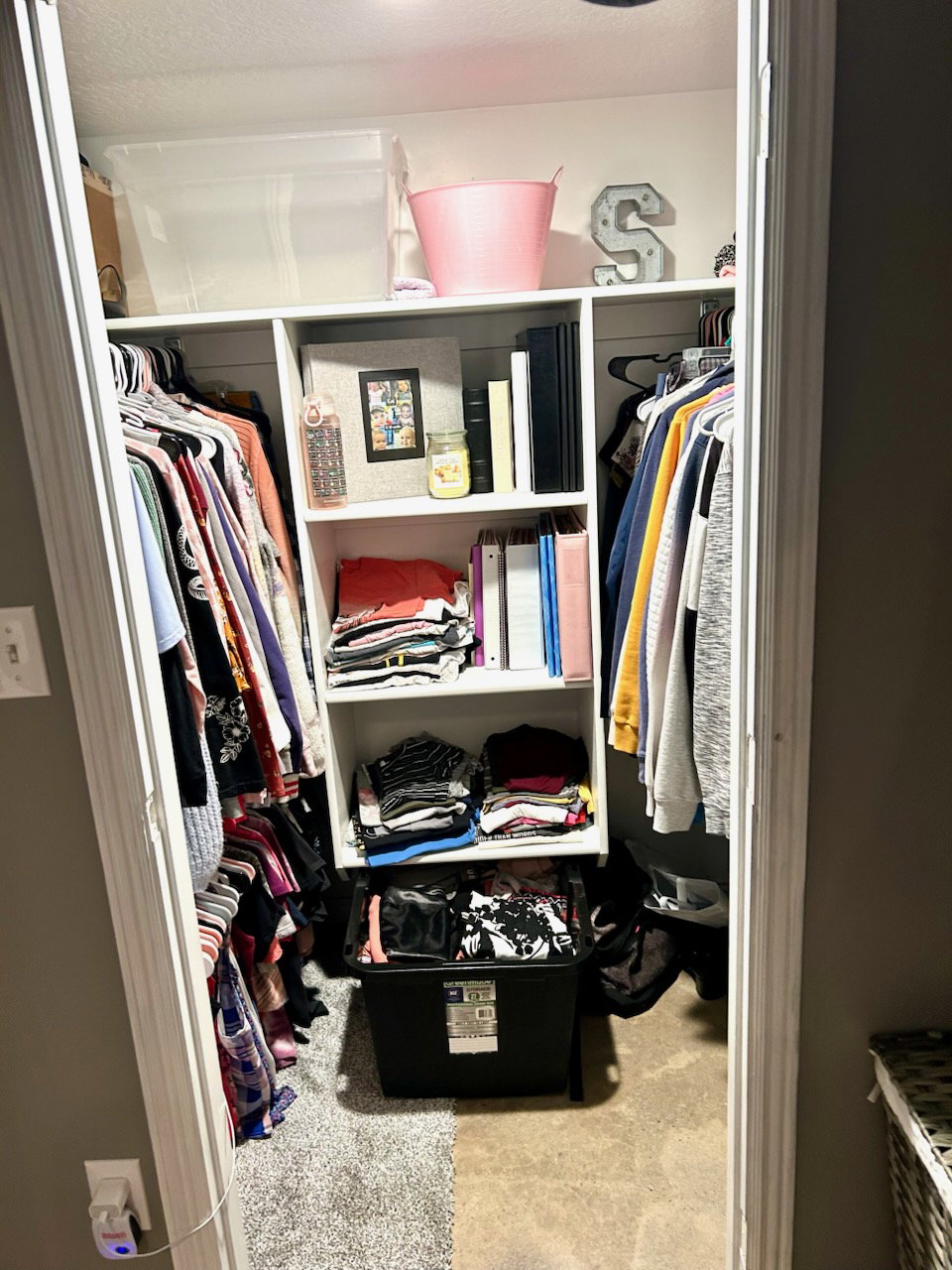 Built-in shelving unit featuring multiple storage cubbies and upper storage