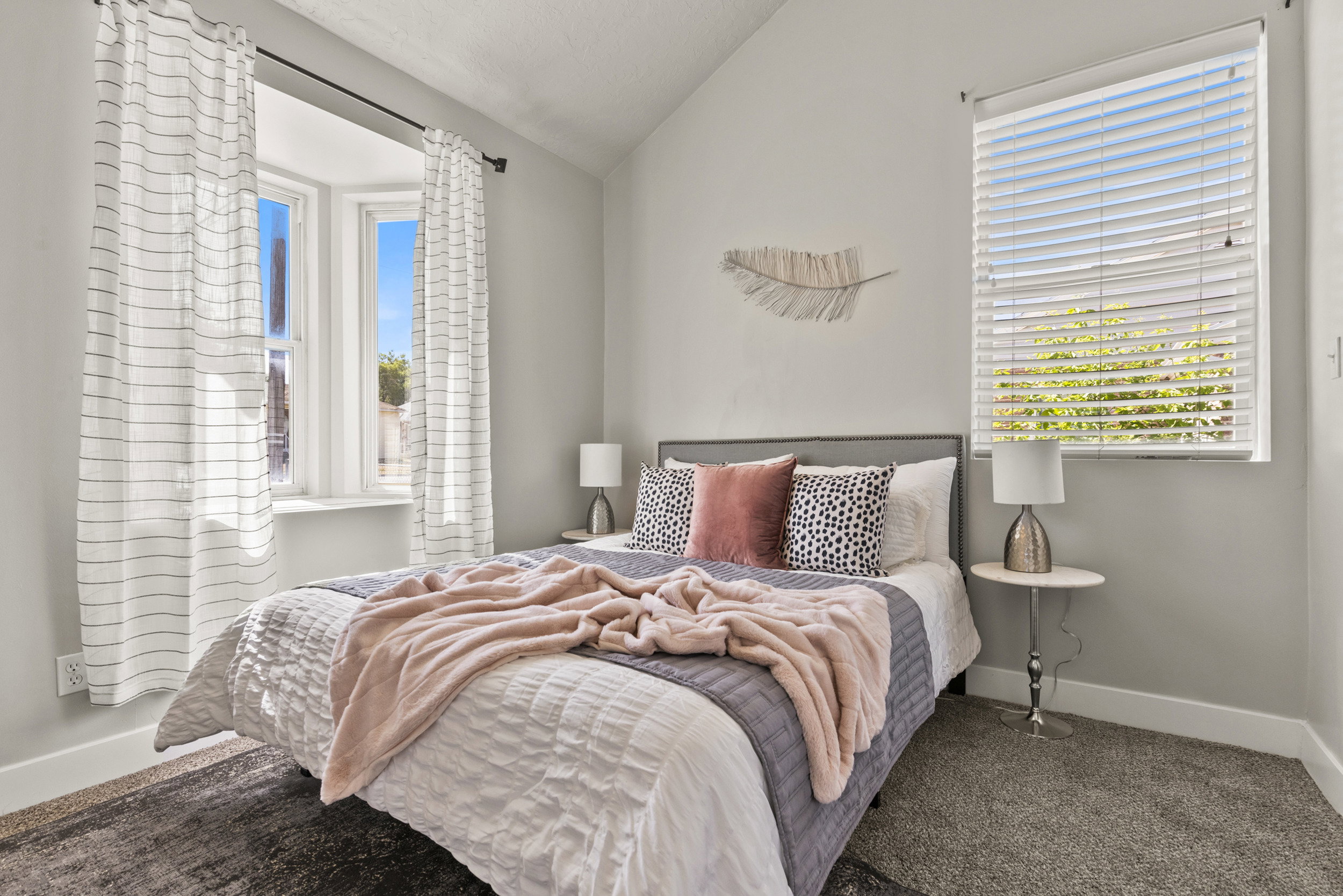 Bedroom featuring a vaulted ceiling and plush carpet flooring