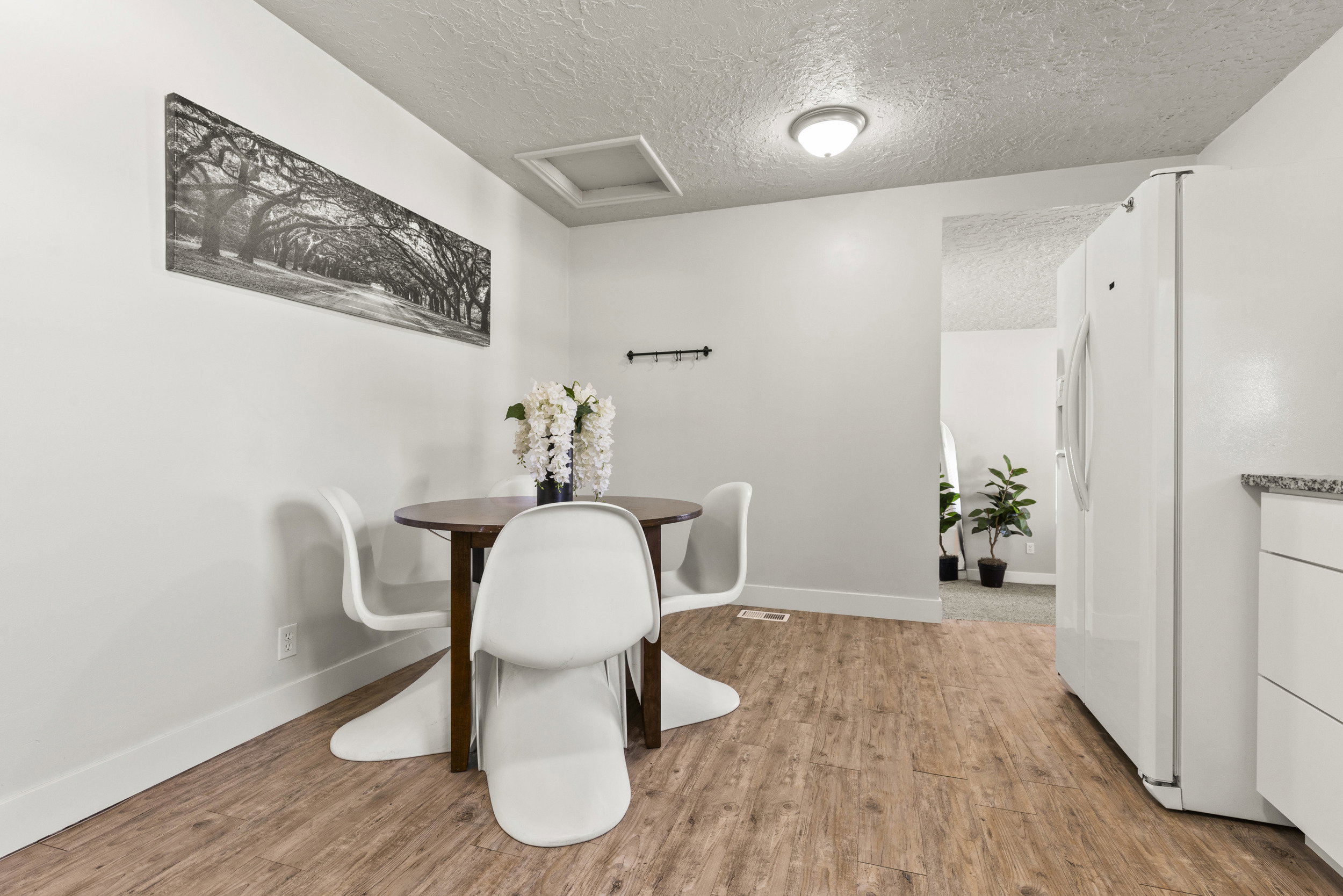 Dining area featuring wood-finish flooring and white walls