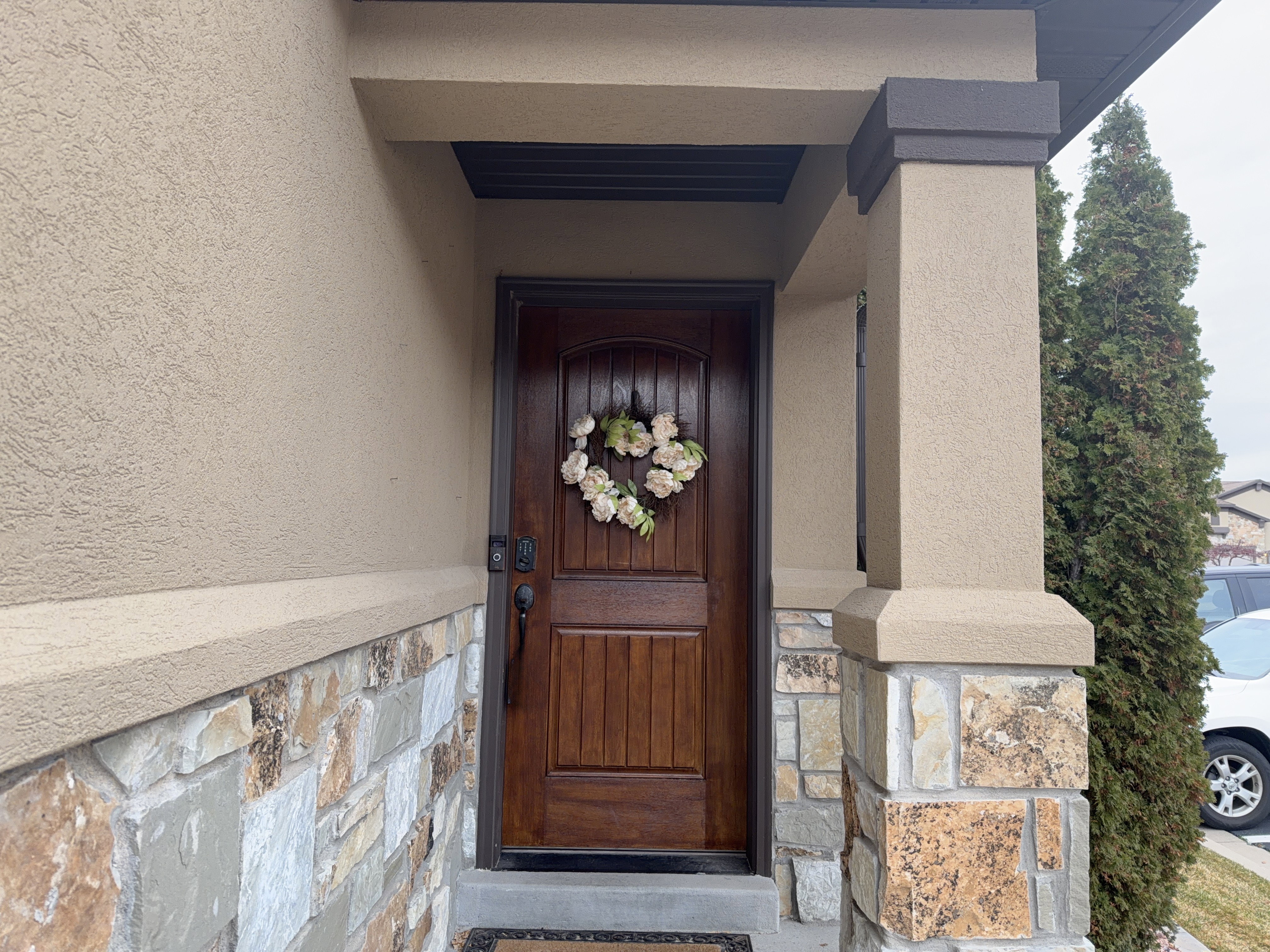 Warm wood-finish entry door with a multi-pane design