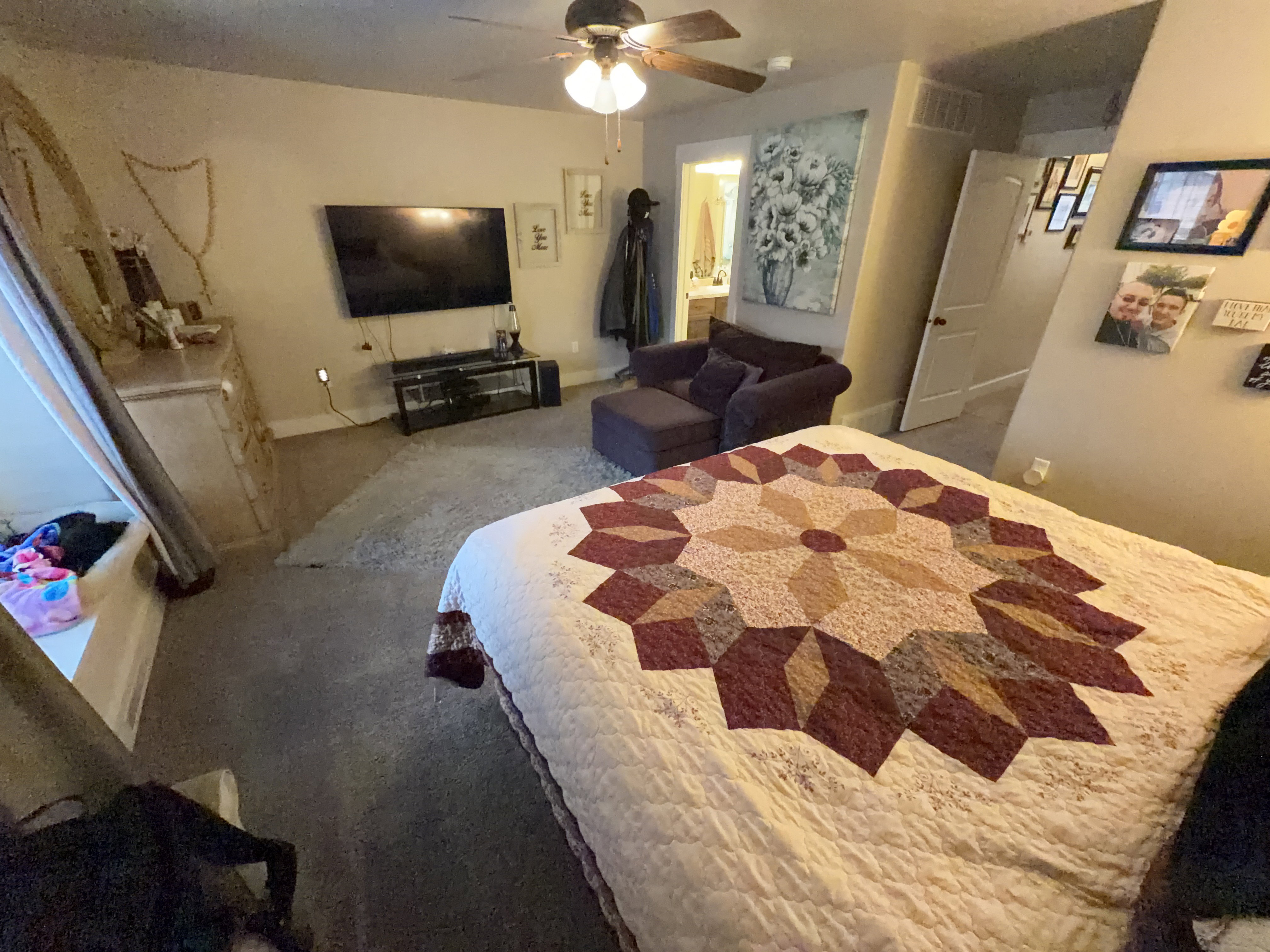 Spacious room featuring carpeting, ceiling fan with light fixture, and a built-in window seat