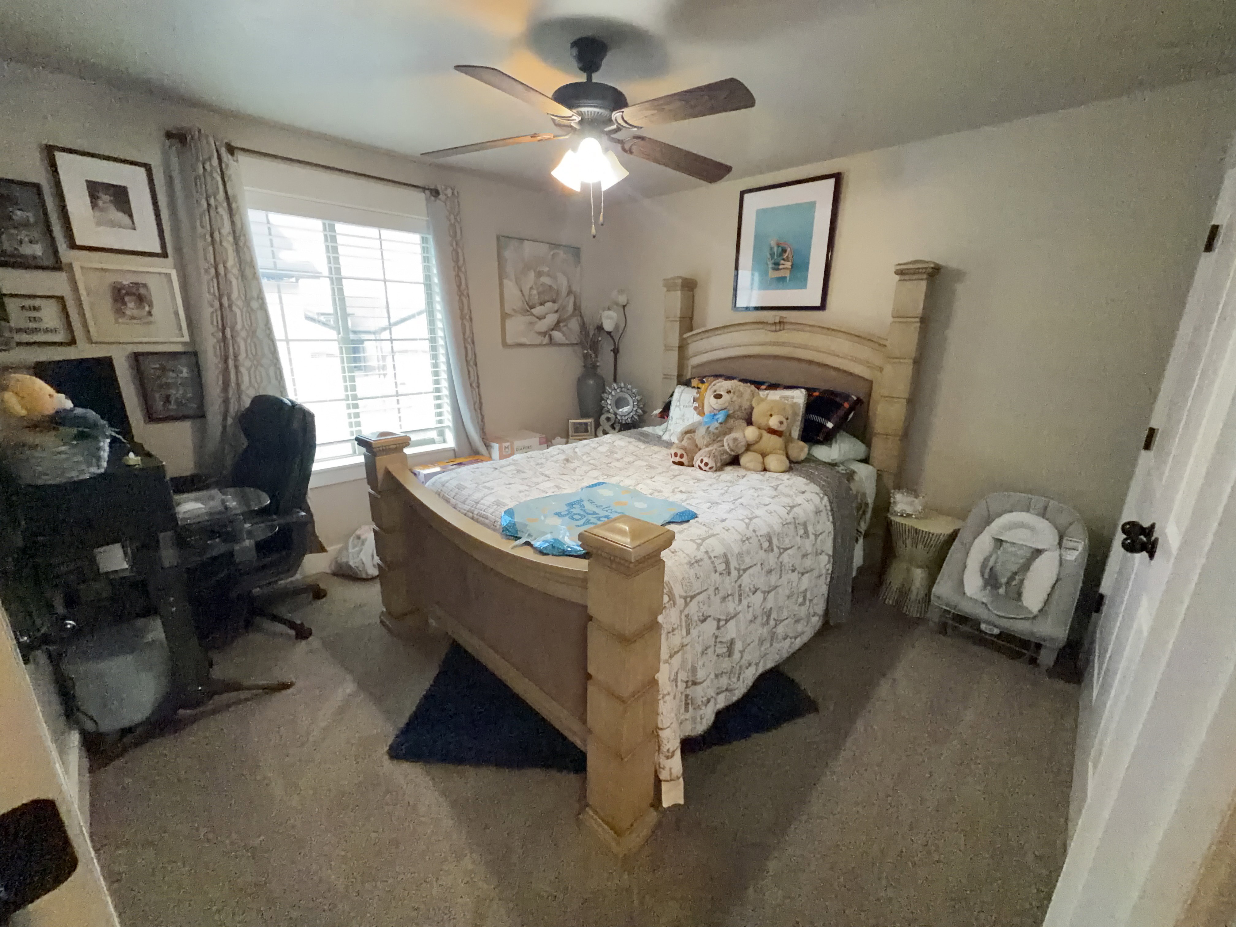 Carpeted room featuring a ceiling fan with integrated lighting, a window with blinds and drapes, and neutral wall paint