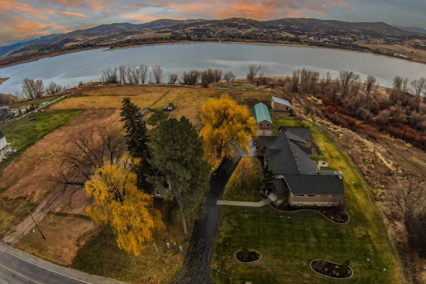Expansive property with a large body of water in the background and distant mountains