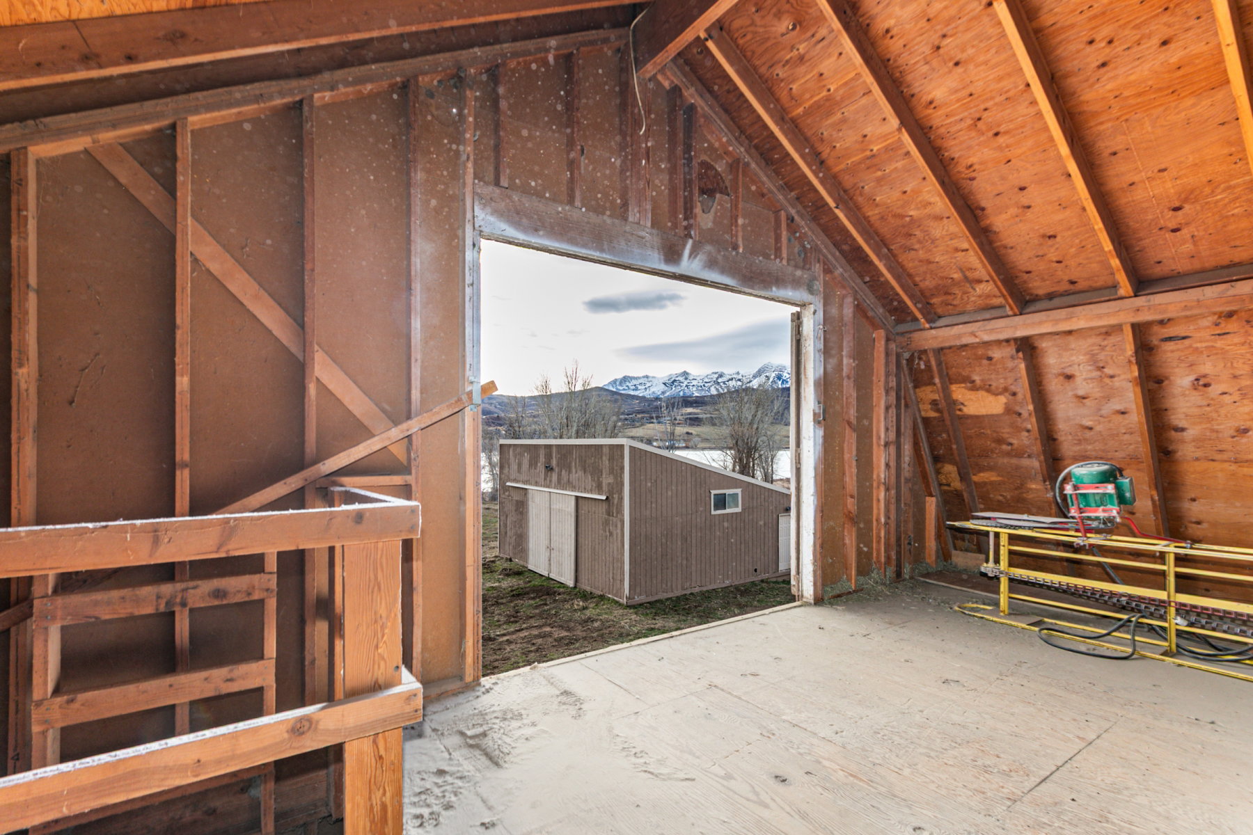 Open structure with exposed wood framing and a pitched roof